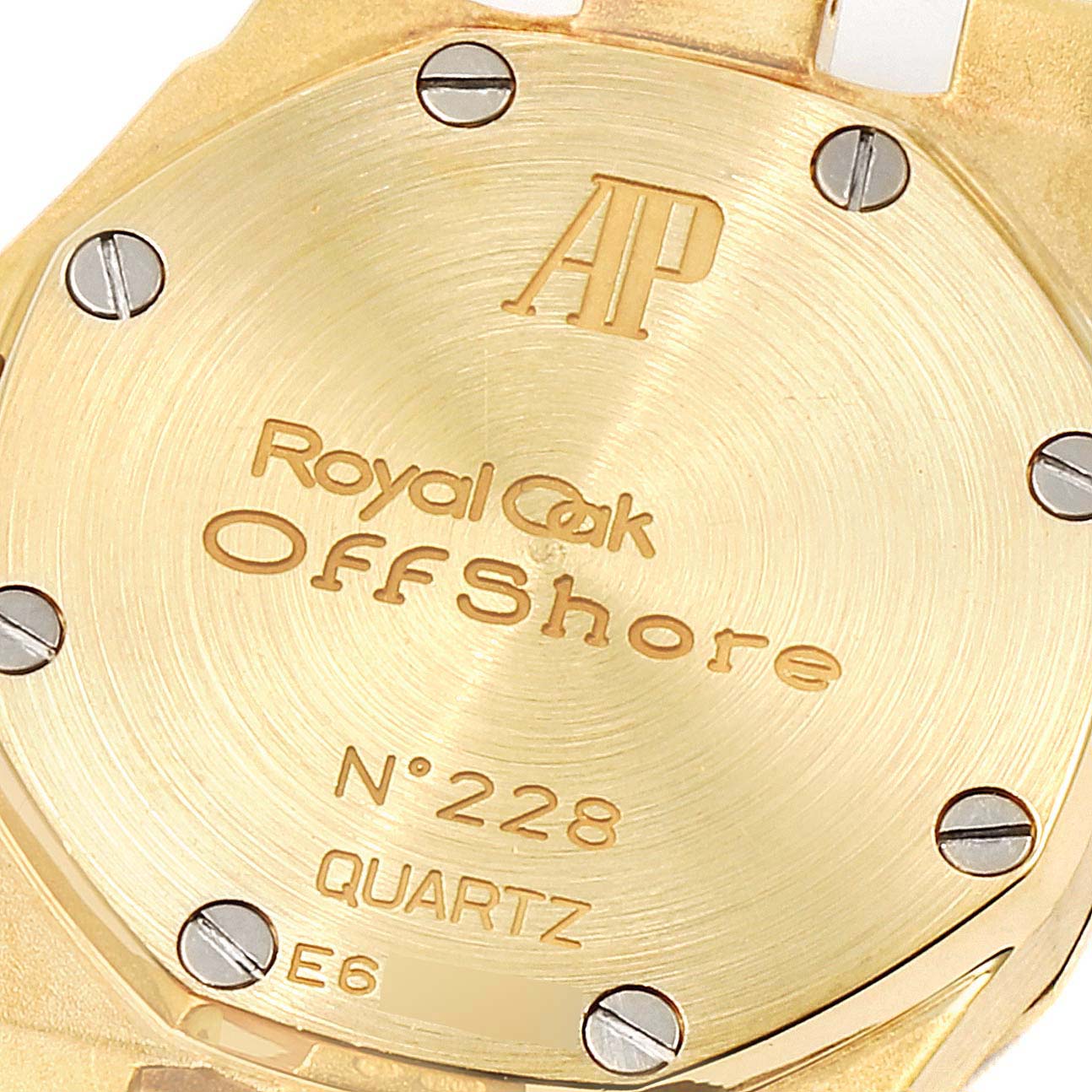 The image shows the back case of the Audemars Piguet Royal Oak Offshore 67151BA.ZZ.1108BA.01 Women's Yellow Gold Mother of Pearl Dial 67151BA.ZZ.1108BA.01 Women's Yellow Gold Mother of Pearl Dial watch, highlighting the model name, serial number, and brand engraving.