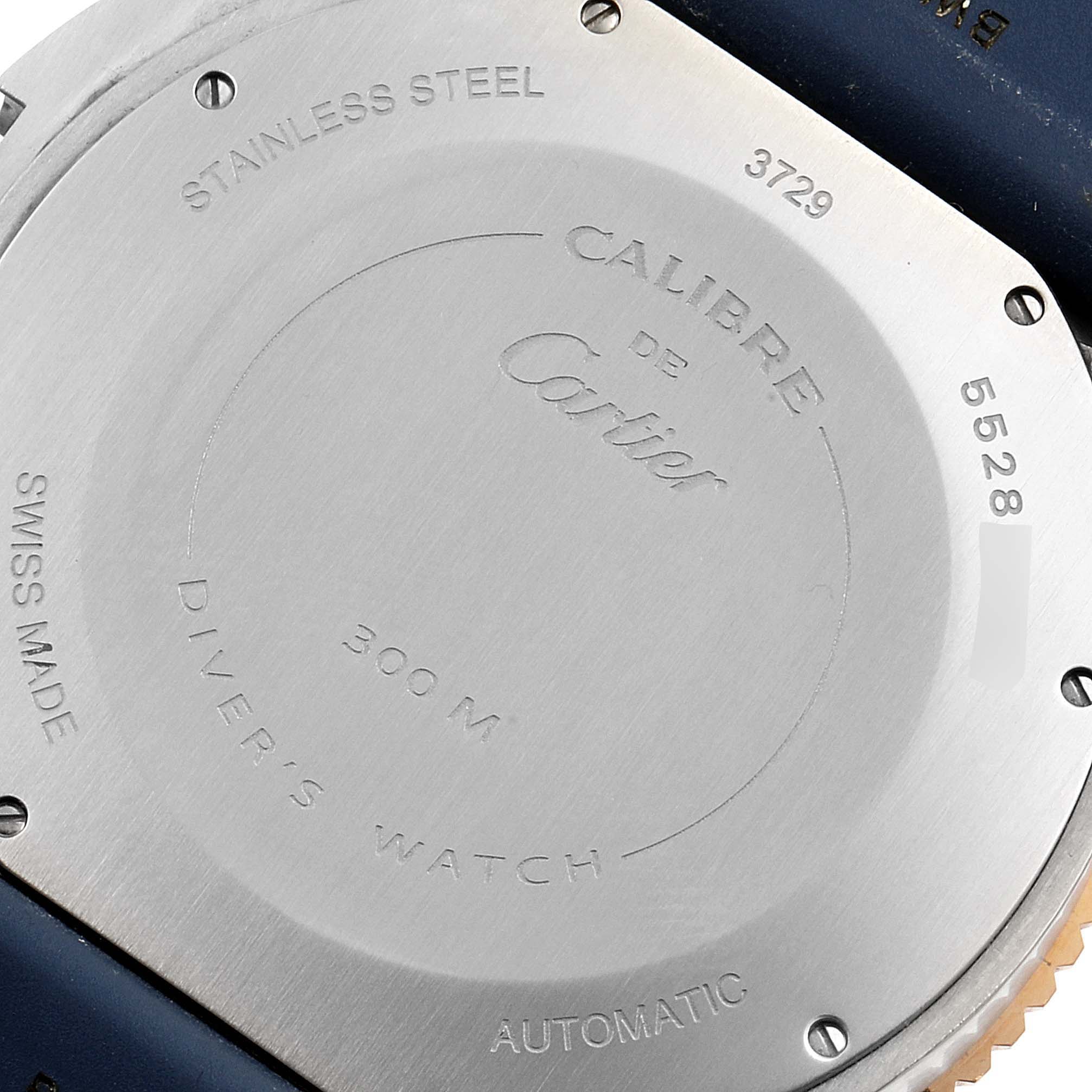 The image shows the back case of a Calibre de Cartier watch by Cartier, highlighting its engravings and stainless steel material.