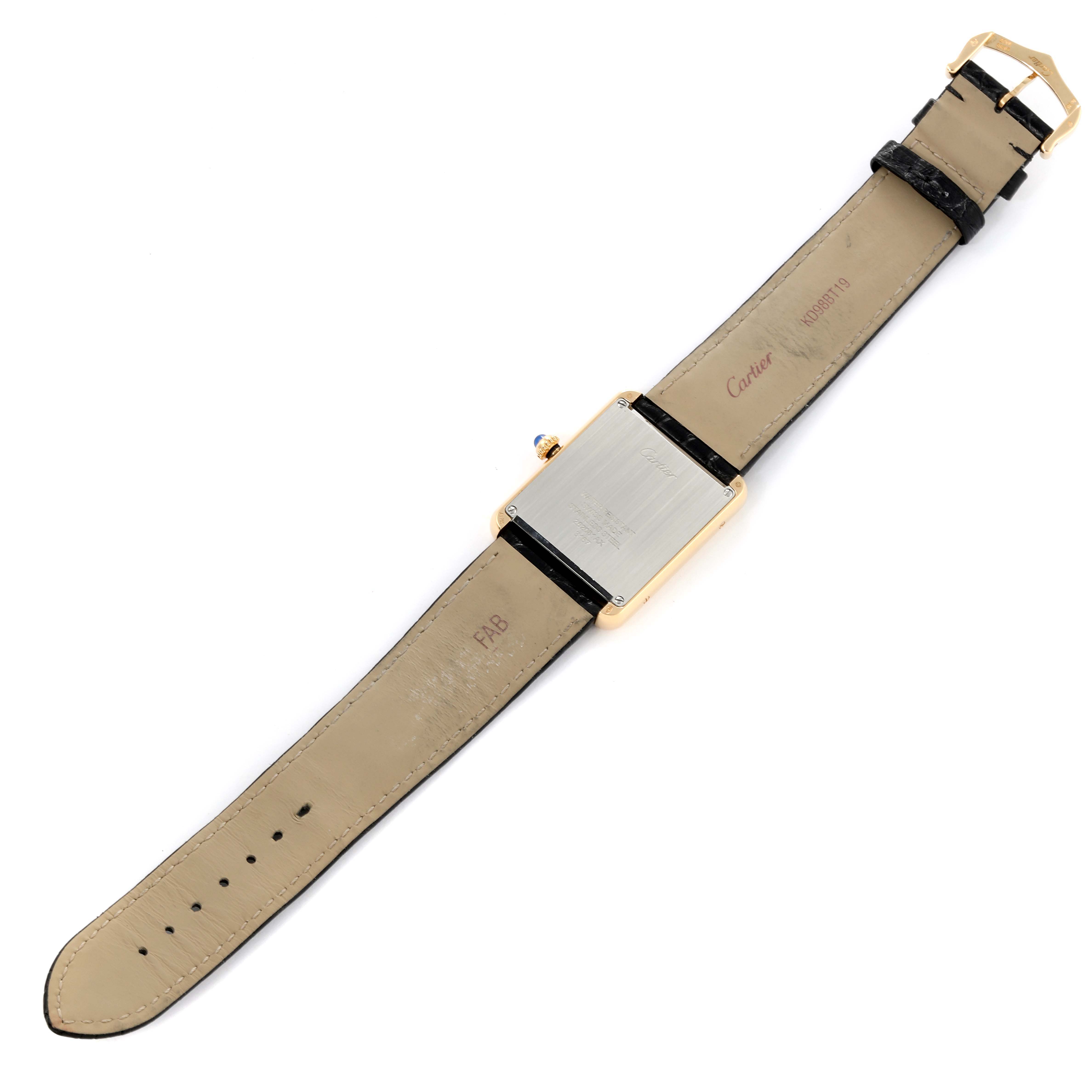 This image shows the back of the Cartier Tank Solo W5200004 Men
s Yellow Gold Silver Dial W5200004 Men
s Yellow Gold Silver Dial watch laid flat, highlighting the strap and casing.