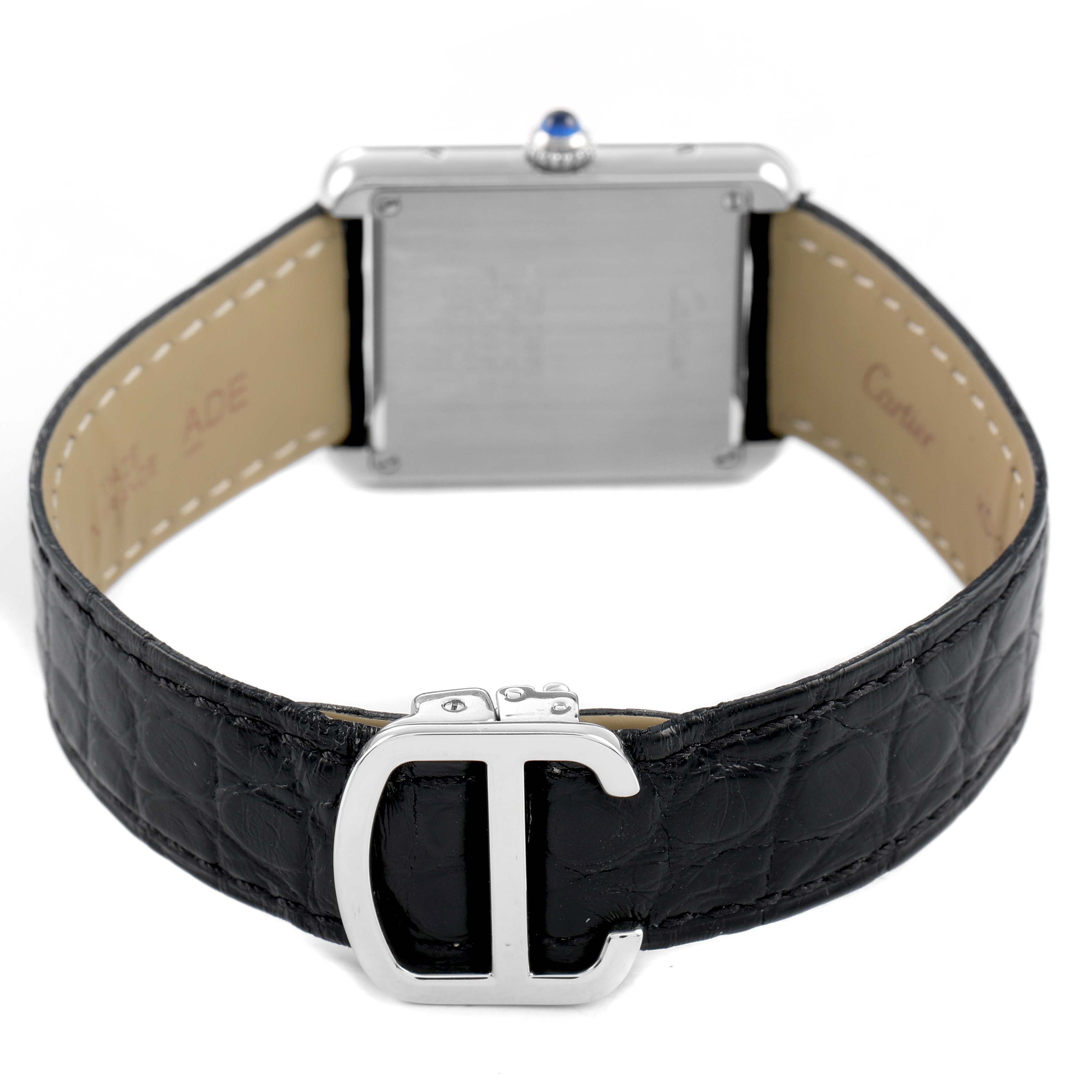 The Cartier Tank Solo W5200005 Women's Stainless Steel Silver Dial watch is shown from the back, highlighting the case, crown, leather strap, and metal buckle.