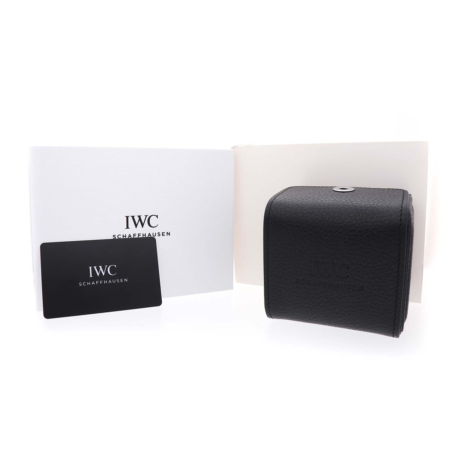 The image shows the IWC Ingenieur IW328903 Men's Stainless Steel Green Dial model's black leather case, a warranty card, and a white document holder.