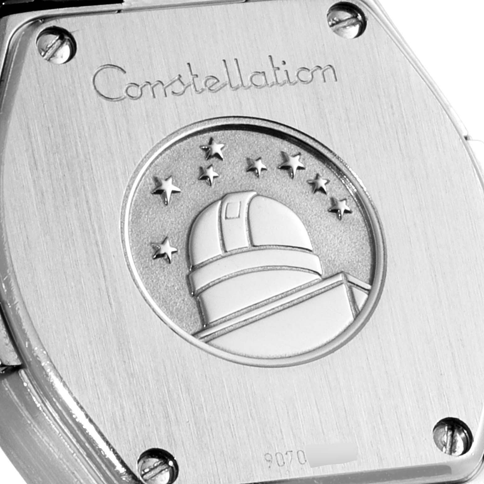 This is a close-up view of the back of the Omega 123.15.24.60.55.003 Women's Stainless Steel Mother of Pearl Dial 123.15.24.60.55.003 Women's Stainless Steel Mother of Pearl Dial Constellation 24 Mother of Pearl Diamond Ladies Watch 123.15.24.60.55.003, showing the observatory emblem and screws.
