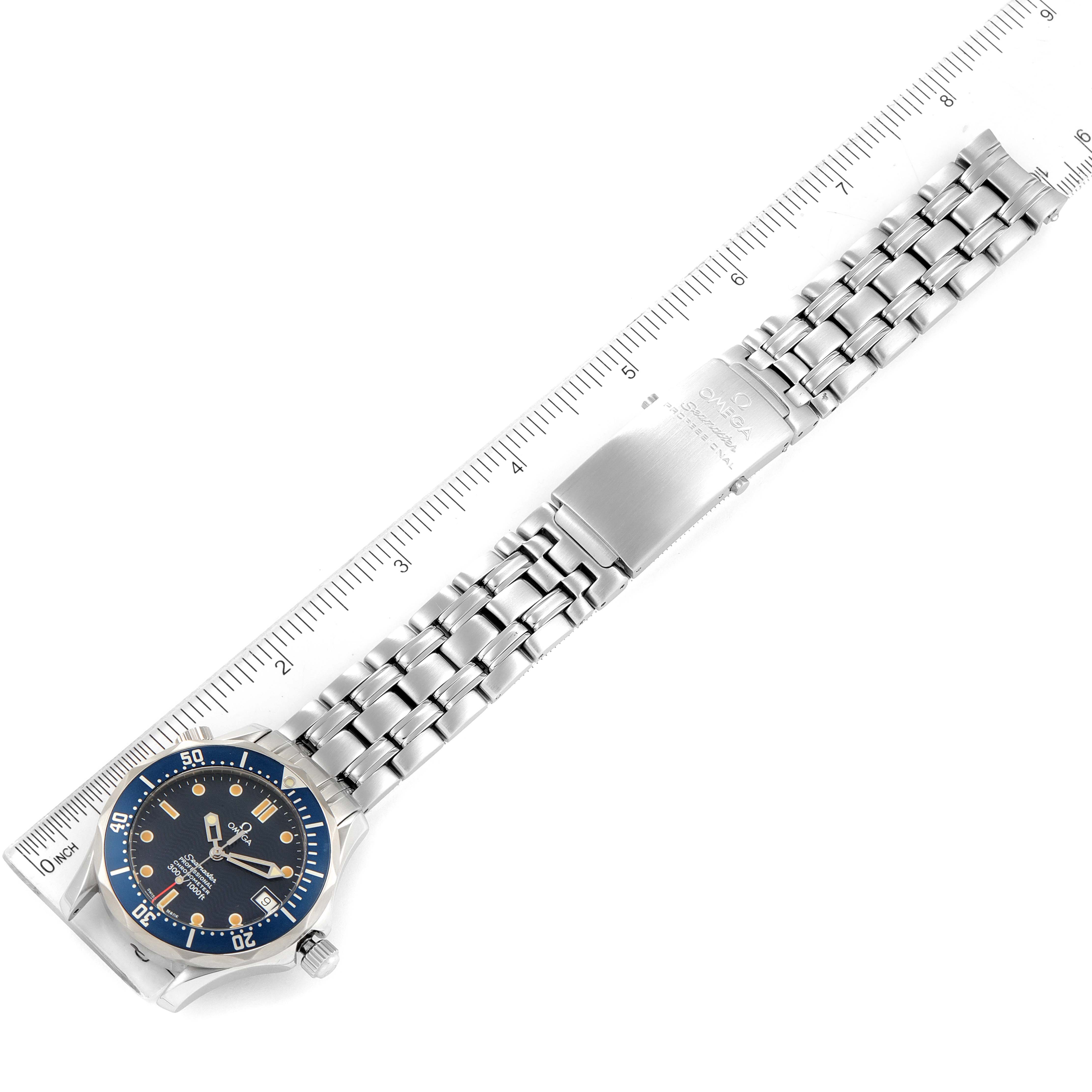The image shows an Omega Seamaster 2551.80.00 Men's Stainless Steel Blue Dial 2551.80.00 Men's Stainless Steel Blue Dial watch laid flat with the full stainless steel bracelet and clasp visible, measured against a ruler.