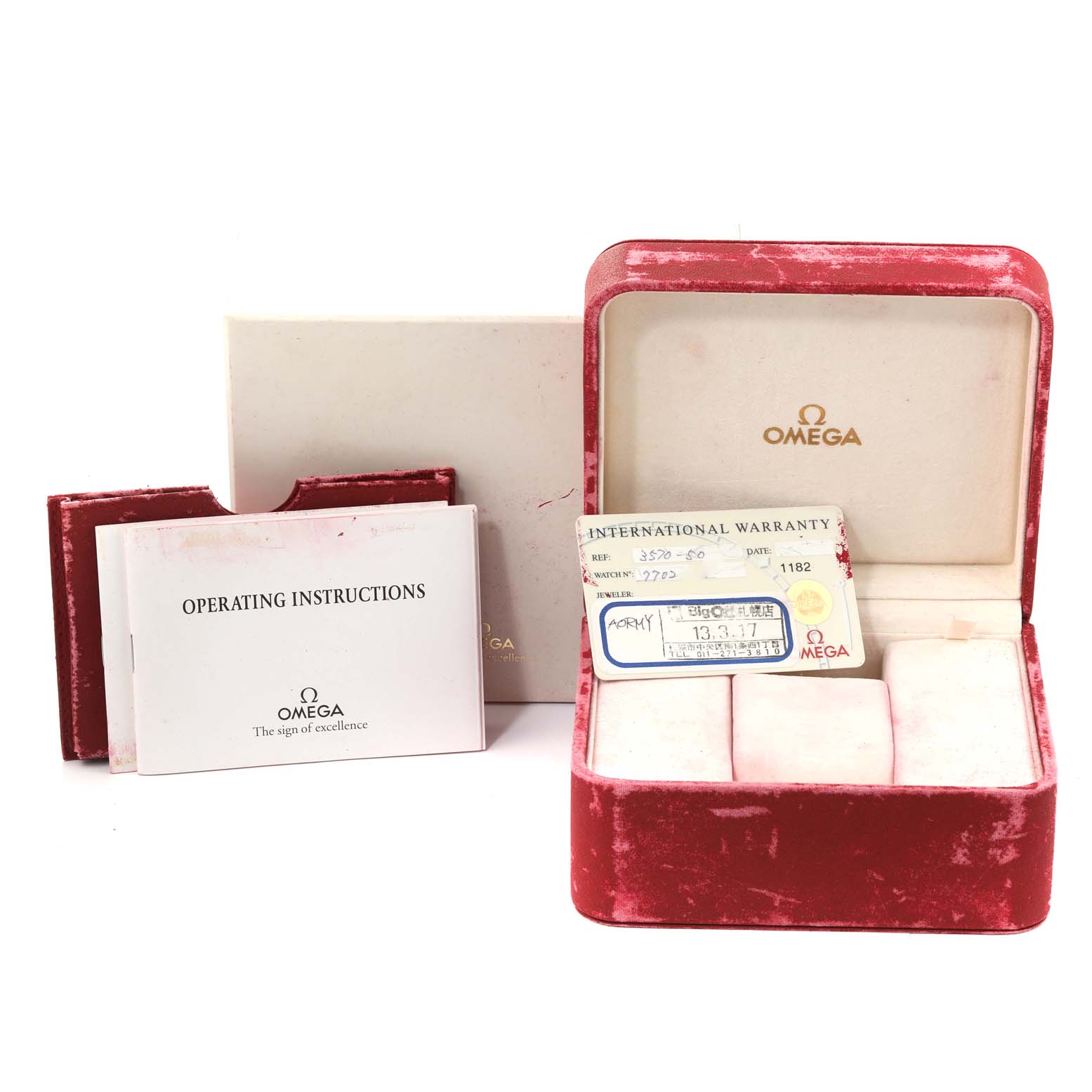 The image shows the packaging and accessories for an Omega Speedmaster 3570.50.00 Men
s Stainless Steel Black Dial 3570.50.00 Men
s Stainless Steel Black Dial watch, including a red case, warranty card, and instruction manual.