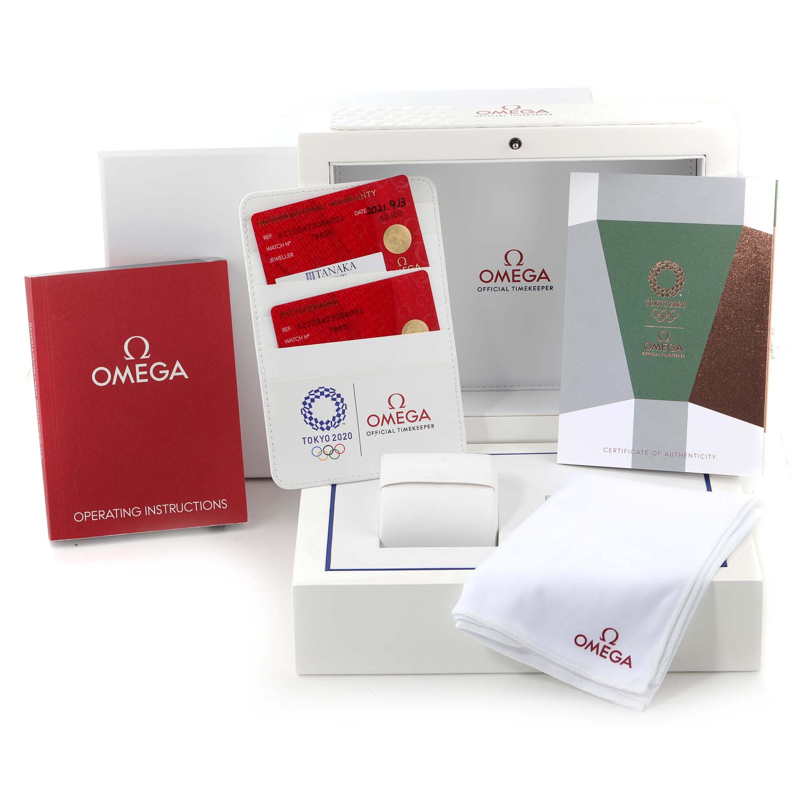 The image shows packaging and accessories for the Omega Speedmaster 522.20.42.30.06.001 Men's Stainless Steel Grey Dial 522.20.42.30.06.001 Men's Stainless Steel Grey Dial, including the box, operating instructions, authenticity cards, and cloth.