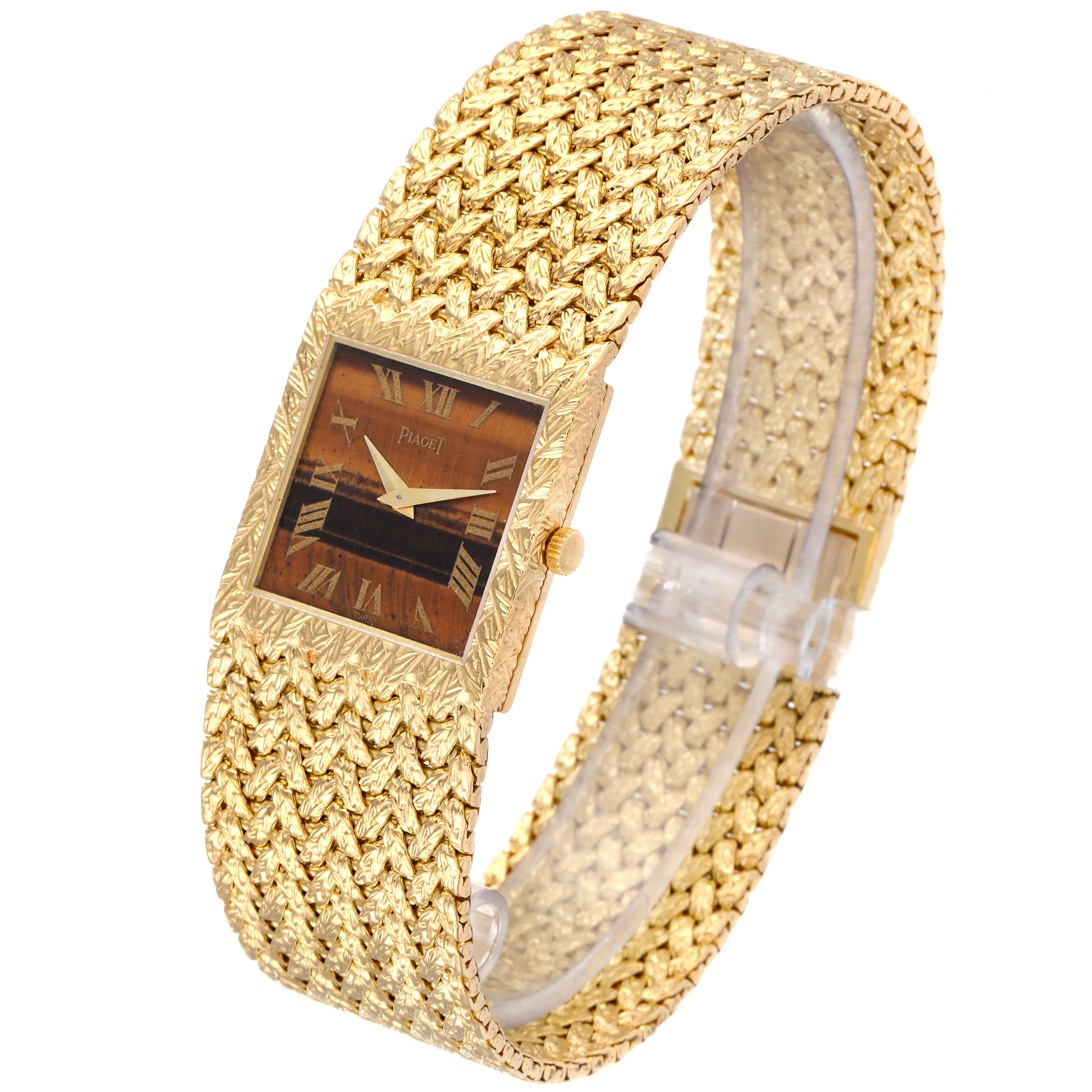 The image shows a Piaget 9352 D2 Men's Yellow Gold Brown Dial 9352 D2 Men's Yellow Gold Brown Dial 9352 model men's watch with an 18k yellow gold band and a tiger's eye stone dial, viewed from an angled side profile.