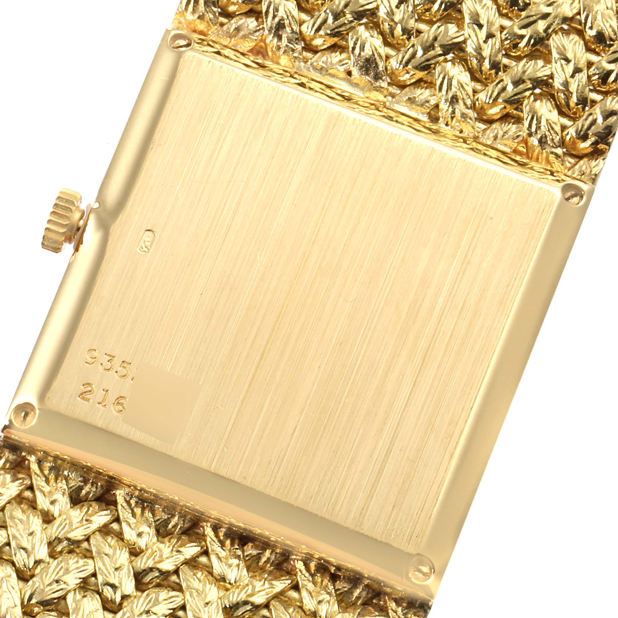 This image shows the back of the Piaget 9352 D2 Men's Yellow Gold Brown Dial 9352 D2 Men's Yellow Gold Brown Dial 9352 model 18k Yellow Gold Tiger Eye Stone Dial Vintage Mens Watch, including the crown and part of the strap.