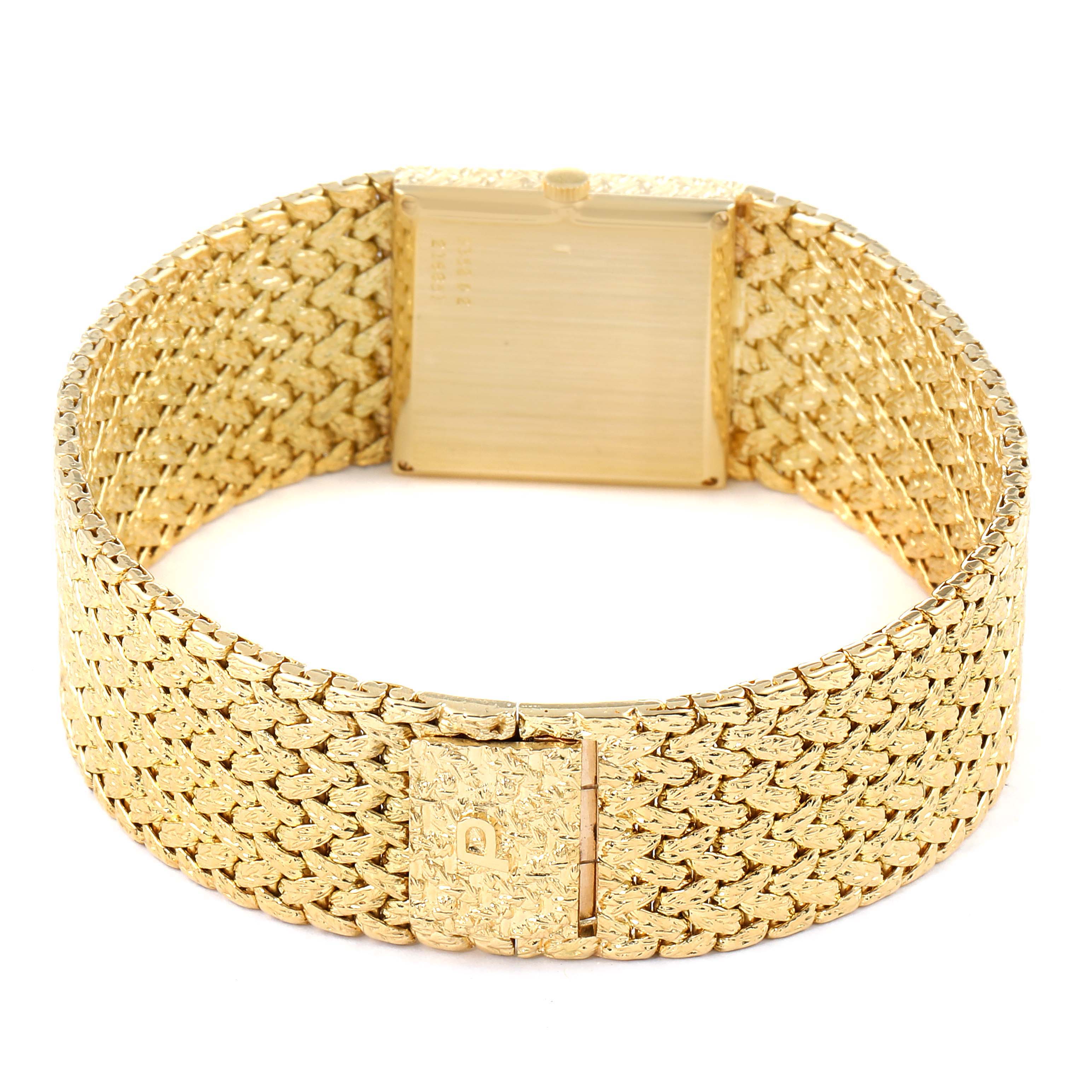 The image shows the back view of the Piaget 9352 D2 Men's Yellow Gold Brown Dial 9352 D2 Men's Yellow Gold Brown Dial 9352 18k Yellow Gold Tiger Eye Stone Dial Vintage Mens Watch, focusing on its textured band and clasp.