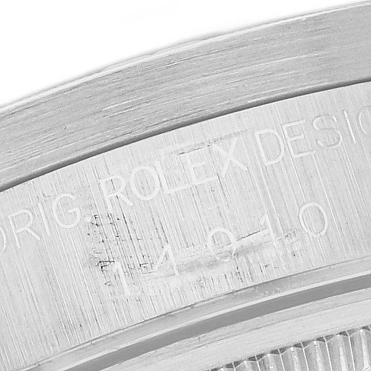 This image shows an up-close view focusing on the engraved bezel of the Rolex Air-King 14010 Men's Stainless Steel Pink Dial 14010 Men's Stainless Steel Pink Dial watch.