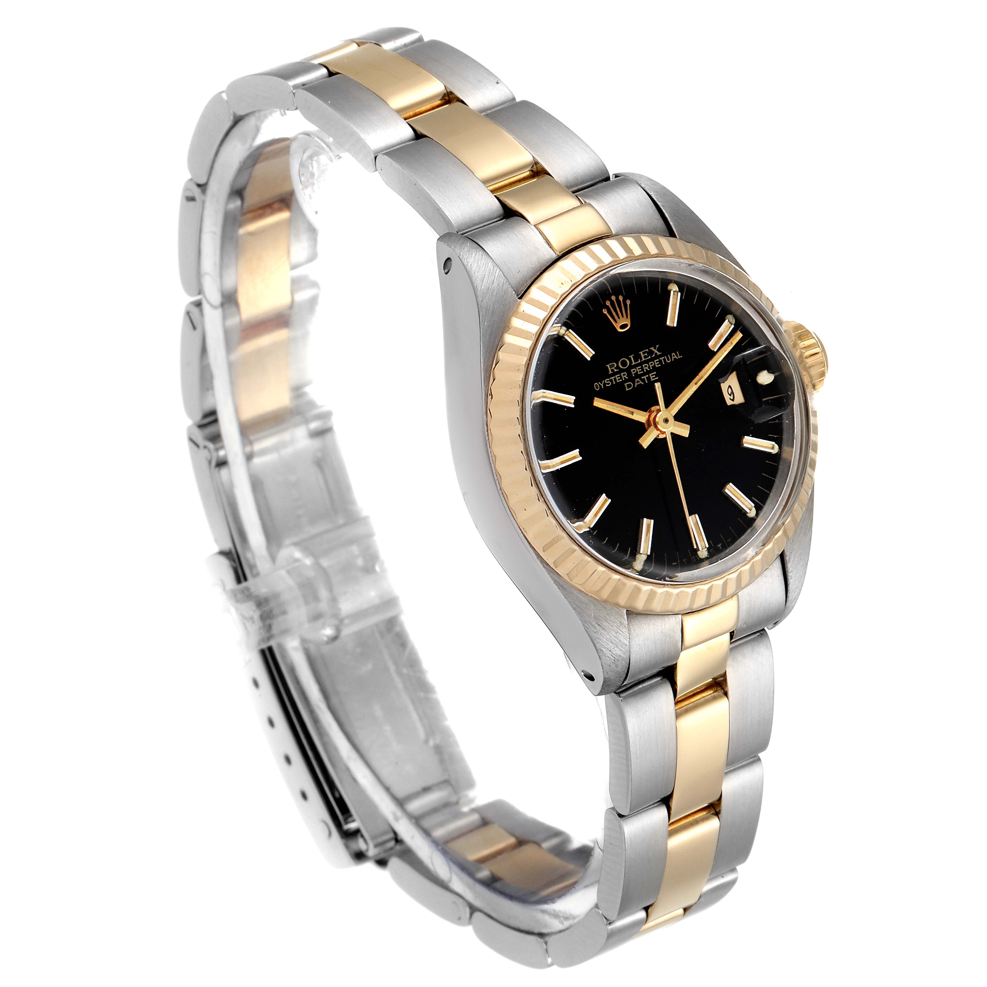 This image shows a Rolex Date 6917 Women's Steel and Gold (two tone) Black Dial 6917 Women's Steel and Gold (two tone) Black Dial model watch from a three-quarter angle, displaying the bezel, dial, and bracelet.