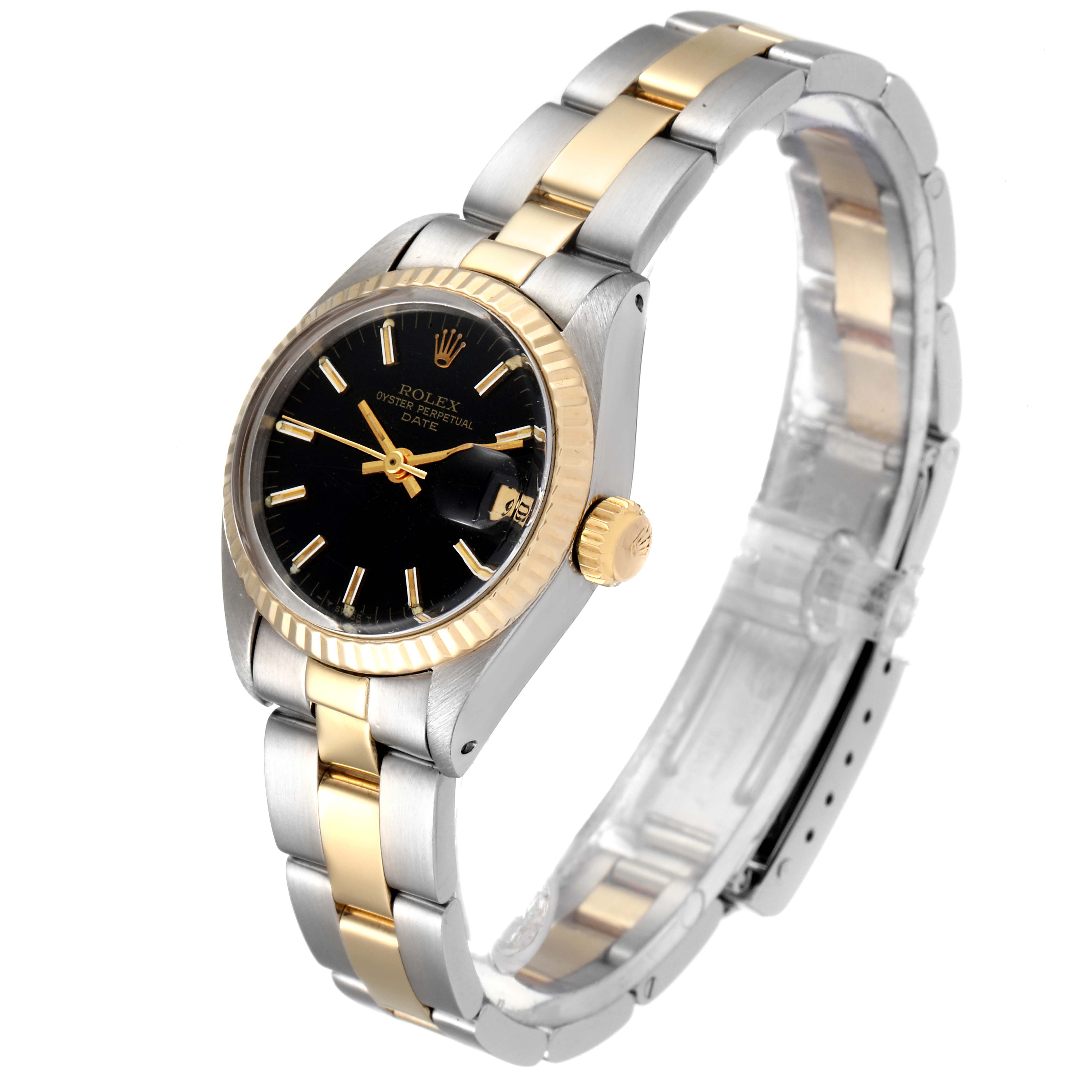 The Rolex Date 6917 Women's Steel and Gold (two tone) Black Dial 6917 Women's Steel and Gold (two tone) Black Dial model watch is shown at a slight angle, highlighting its black dial, gold bezel, and bicolor bracelet.