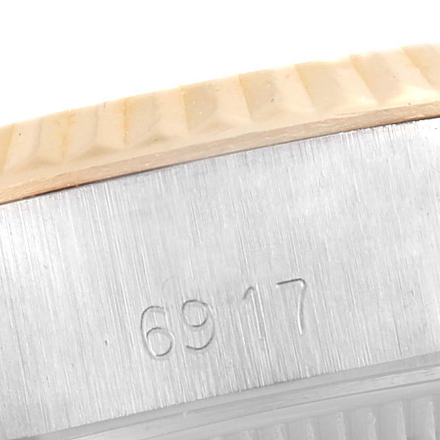 This image shows the side view of the case of a Rolex Date 6917 Women's Steel and Gold (two tone) Black Dial 6917 Women's Steel and Gold (two tone) Black Dial model watch, highlighting the engraved model number.