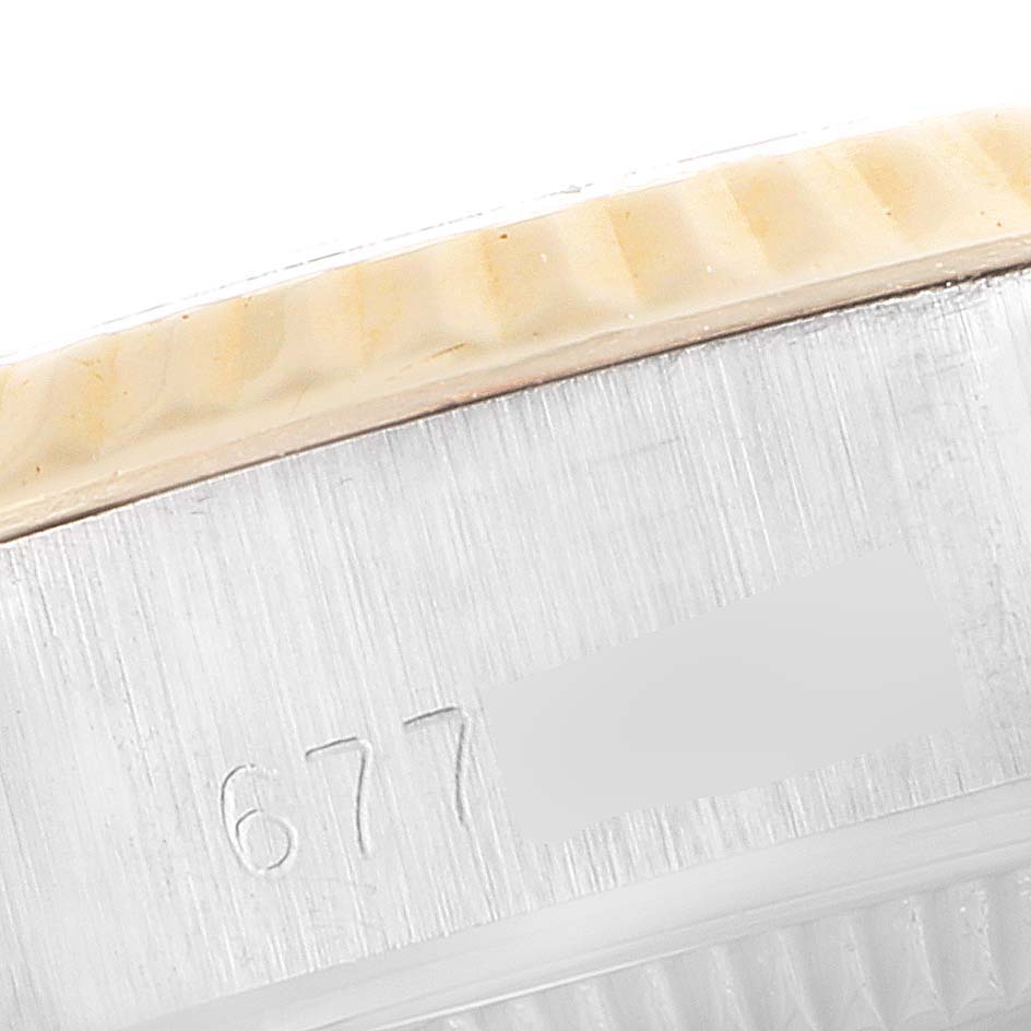 The image shows a close-up of the side casing with engraving on a Rolex Date 6917 Women's Steel and Gold (two tone) Black Dial 6917 Women's Steel and Gold (two tone) Black Dial model watch.