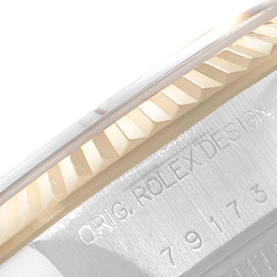 This close-up image shows the fluted bezel and case side of a Rolex Datejust 79173 Women
s Steel and Gold (two tone) Silver Dial 79173 Women
s Steel and Gold (two tone) Silver Dial watch, displaying part of its "Orig. Rolex Design" engraving.