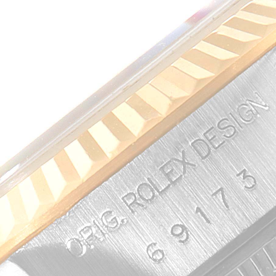 The image focuses on the fluted bezel and case side engraving of a Rolex Datejust 69173 Women's Steel and Gold (two tone) Black Dial 69173 Women's Steel and Gold (two tone) Black Dial watch.