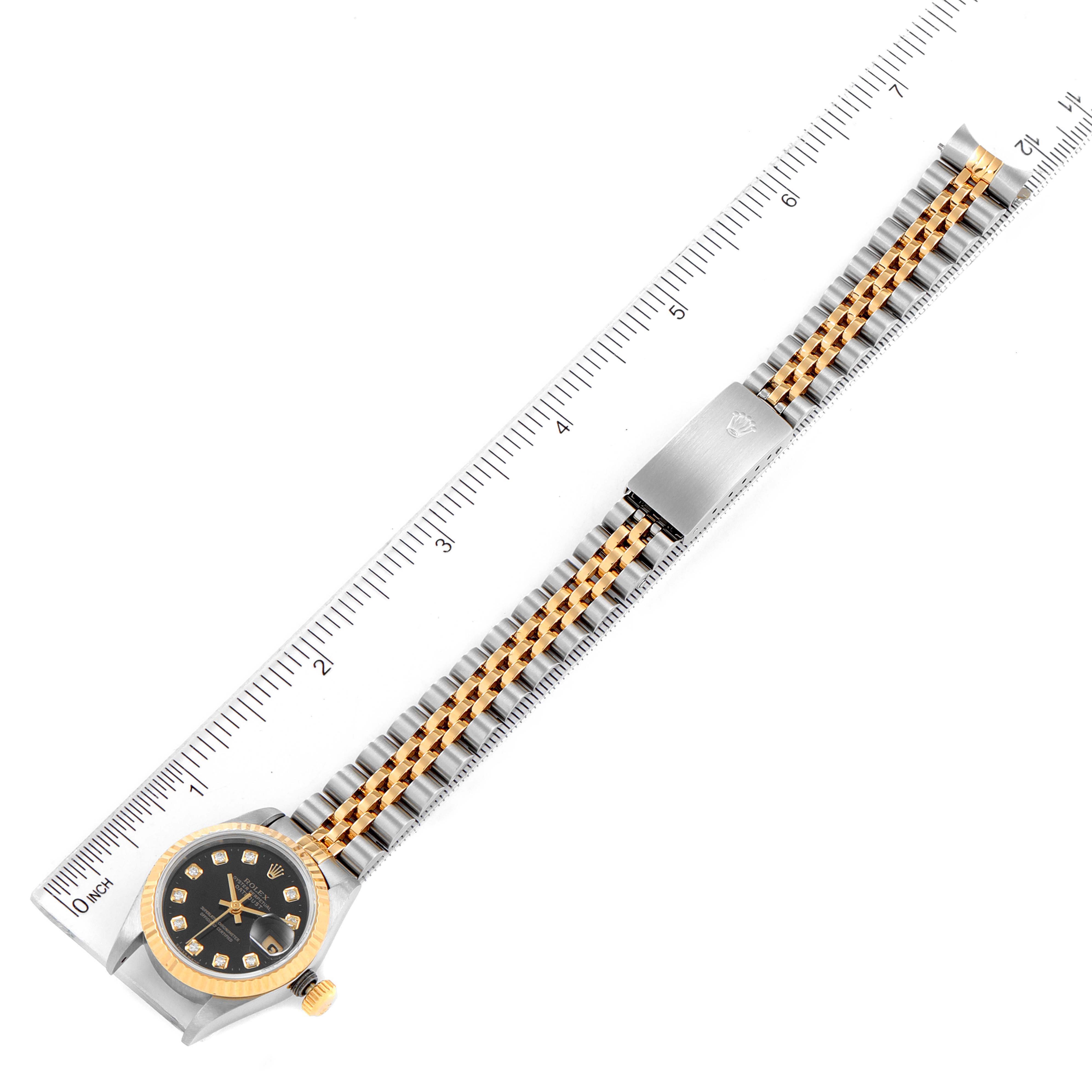 The image shows an overhead view of a Rolex Datejust 69173 Women's Steel and Gold (two tone) Black Dial 69173 Women's Steel and Gold (two tone) Black Dial watch with a stainless steel and gold jubilee bracelet.