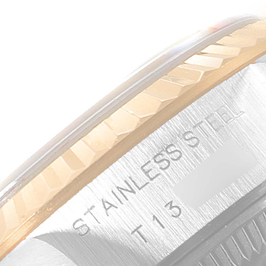 The image shows a close-up of the bezel and part of the case of a Rolex Datejust 69173 Women's Steel and Gold (two tone) Black Dial 69173 Women's Steel and Gold (two tone) Black Dial watch, highlighting the "STAINLESS STEEL" engraving.