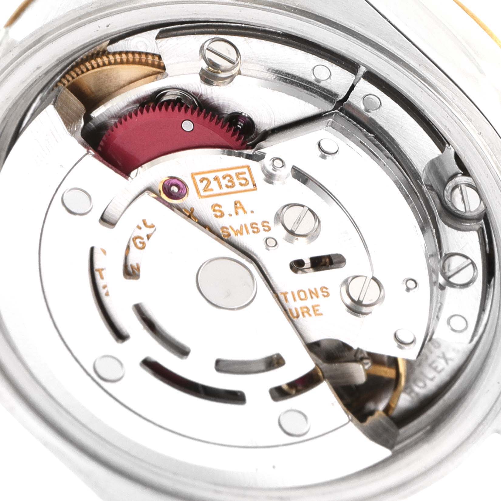 This close-up image shows the internal movement mechanism of a Rolex Datejust 69173 Women's Steel and Gold (two tone) Blue Dial 69173 Women's Steel and Gold (two tone) Blue Dial watch, featuring detailed parts like gears and screws.