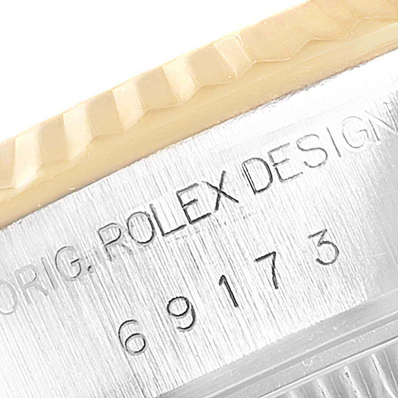 This image shows a close-up of the side engraving and bezel of a Rolex Datejust 69173 Women's Steel and Gold (two tone) Blue Dial 69173 Women's Steel and Gold (two tone) Blue Dial watch.