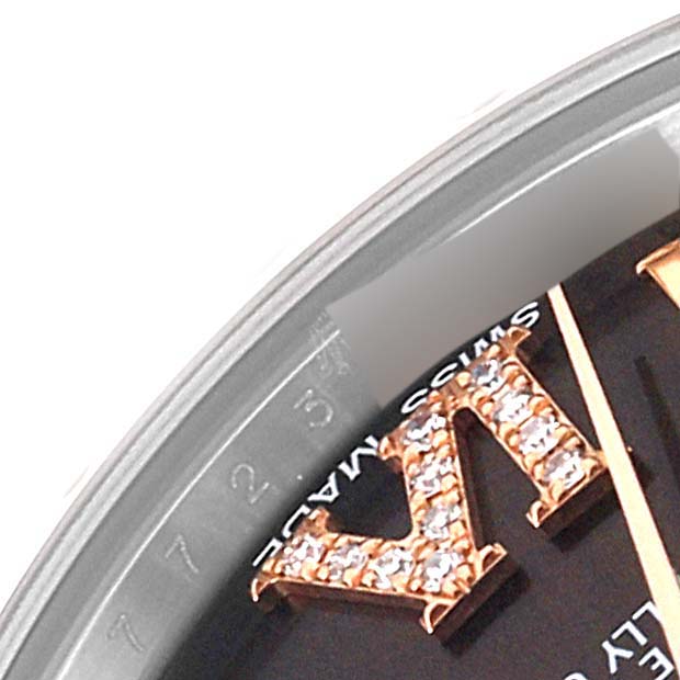 A close-up of the dial of a mid-size Rolex watch, showing diamond-studded numerals and the text "SWISS MADE."