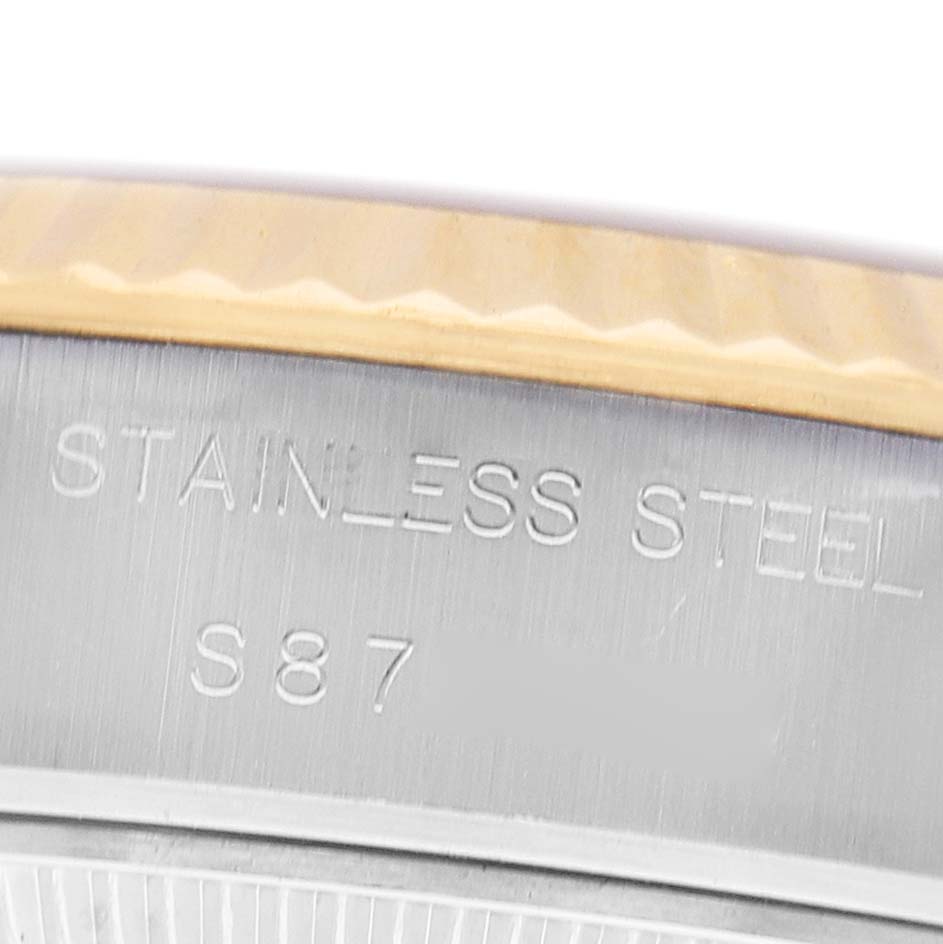 The image shows a close-up of the stainless steel case's edge with engravings on the Rolex Datejust 69173 Women's Steel and Gold (two tone) Champagne Dial watch.