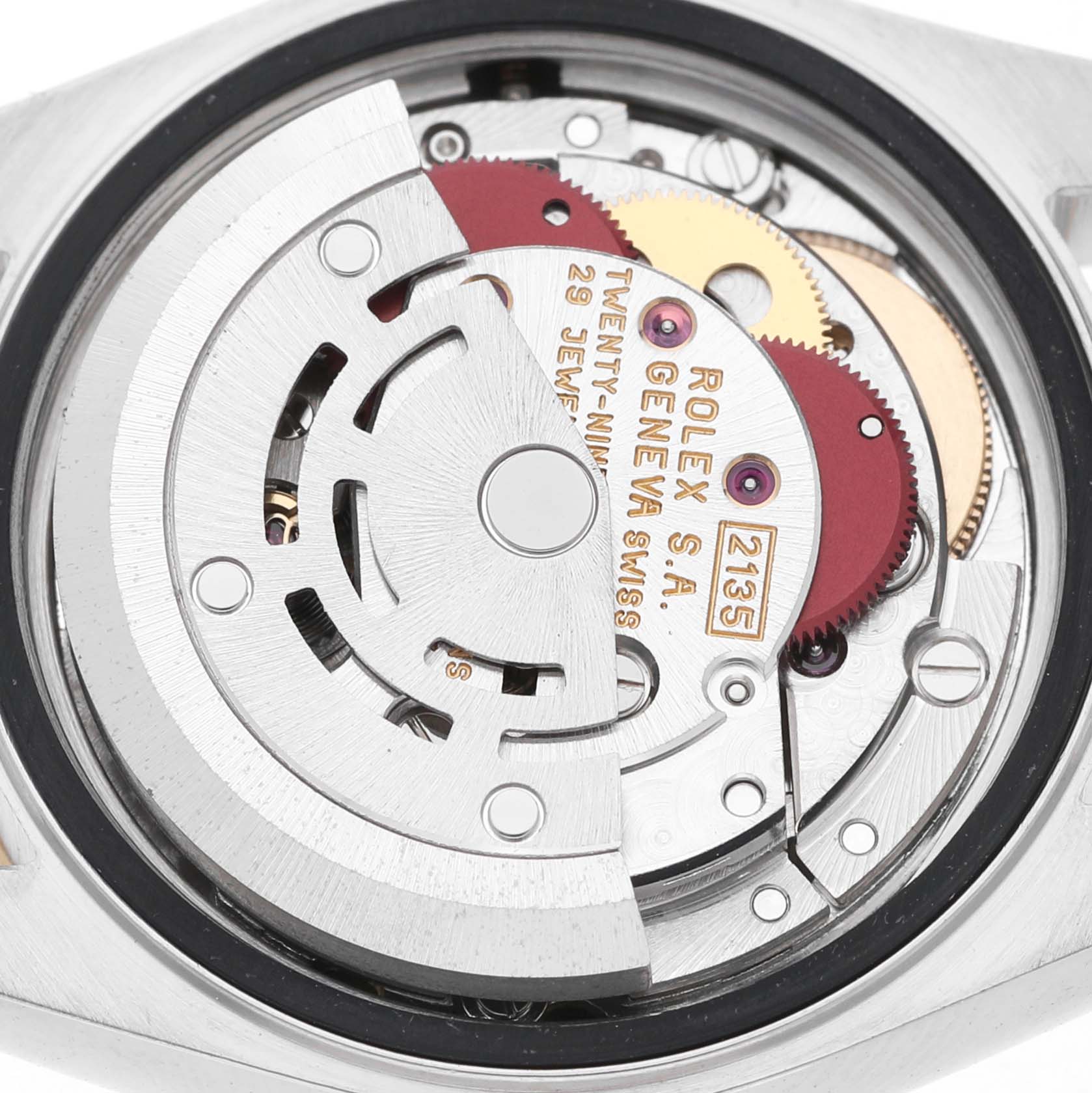 The image shows the movement mechanism of a Rolex Datejust 69173 Women's Steel and Gold (two tone) Champagne Dial watch from a rear angle, highlighting gears and intricate parts.