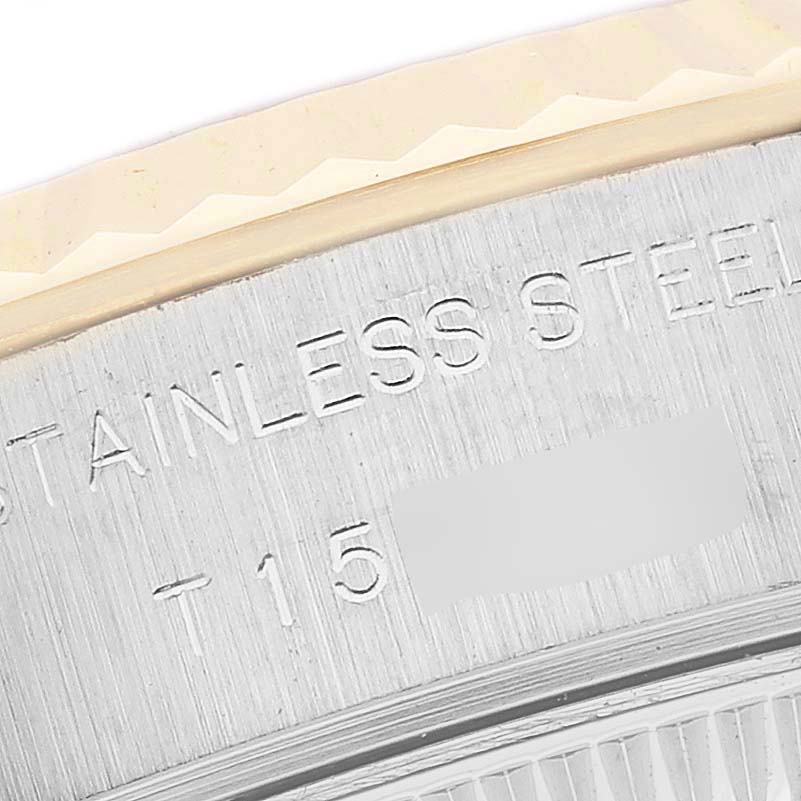 The image shows a close-up of the edge of a Rolex Datejust 69173 Women's Steel and Gold (two tone) White Dial, focusing on the stainless steel outer case and fluted bezel.