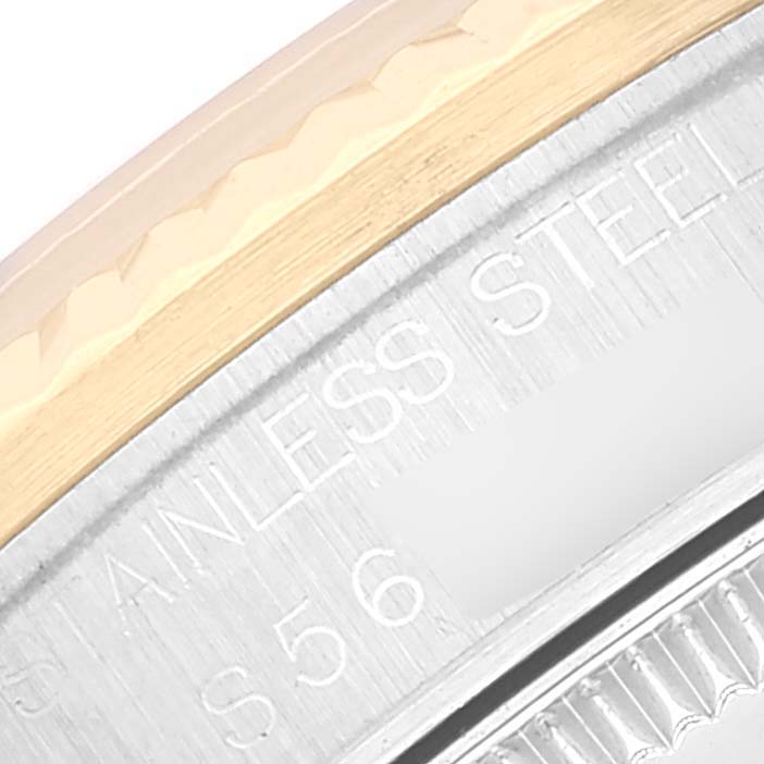 This image shows a close-up of the bezel and case back engraving of a mid-size Rolex watch.