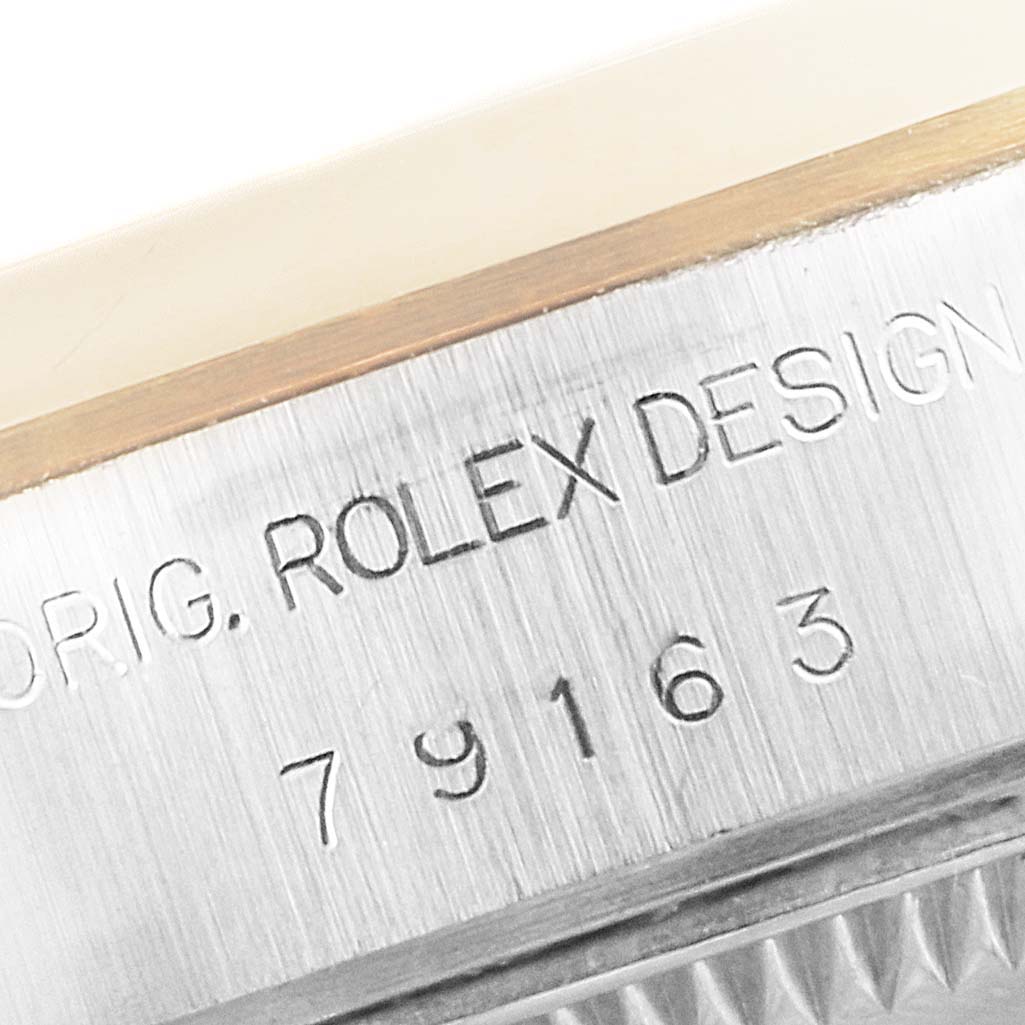 The image shows a close-up of the engraved serial number and "Rolex Design" on the Rolex Datejust 79163 Women's Steel and Gold (two tone) Mother of Pearl Dial 79163 Women's Steel and Gold (two tone) Mother of Pearl Dial model watch.