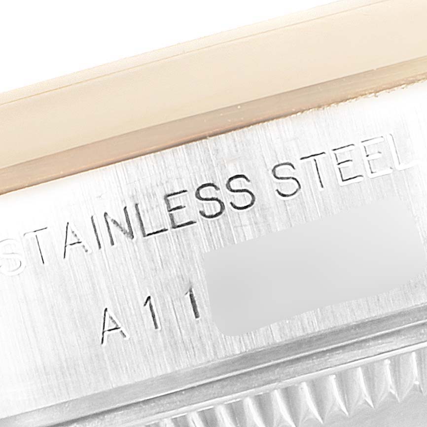 The image shows a close-up of the side profile of a Rolex Datejust 79163 Women's Steel and Gold (two tone) Mother of Pearl Dial 79163 Women's Steel and Gold (two tone) Mother of Pearl Dial watch, highlighting the "STAINLESS STEEL" engraving.