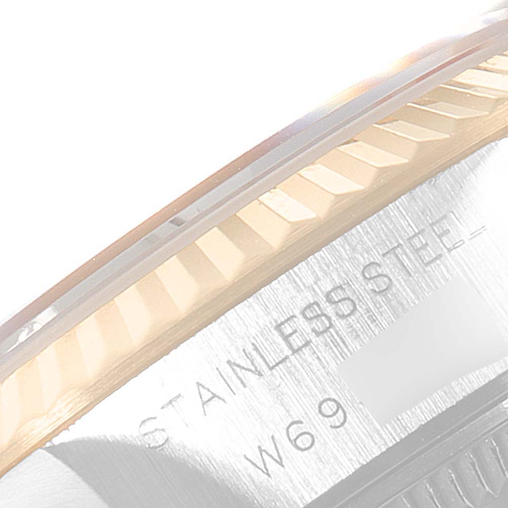 The image shows a close-up of the side of the bezel and part of the case back engraving on a Rolex Datejust 69173 Women
s Steel and Gold (two tone) Champagne Dial 69173 Women
s Steel and Gold (two tone) Champagne Dial watch.