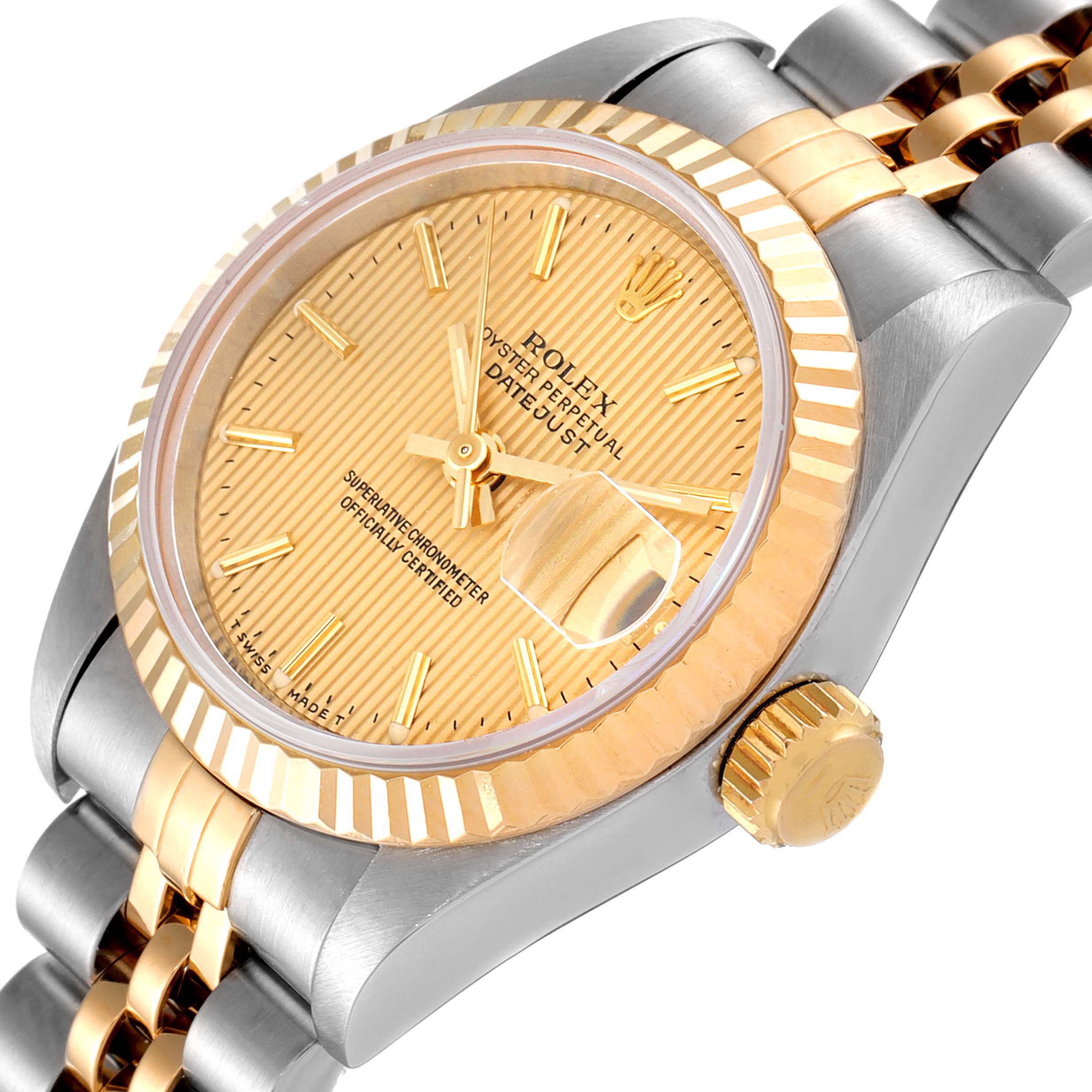 This image shows a close-up angled view of the Rolex Datejust 69173 Women
s Steel and Gold (two tone) Champagne Dial 69173 Women
s Steel and Gold (two tone) Champagne Dial watch, highlighting its gold dial, bezel, and two-tone bracelet.