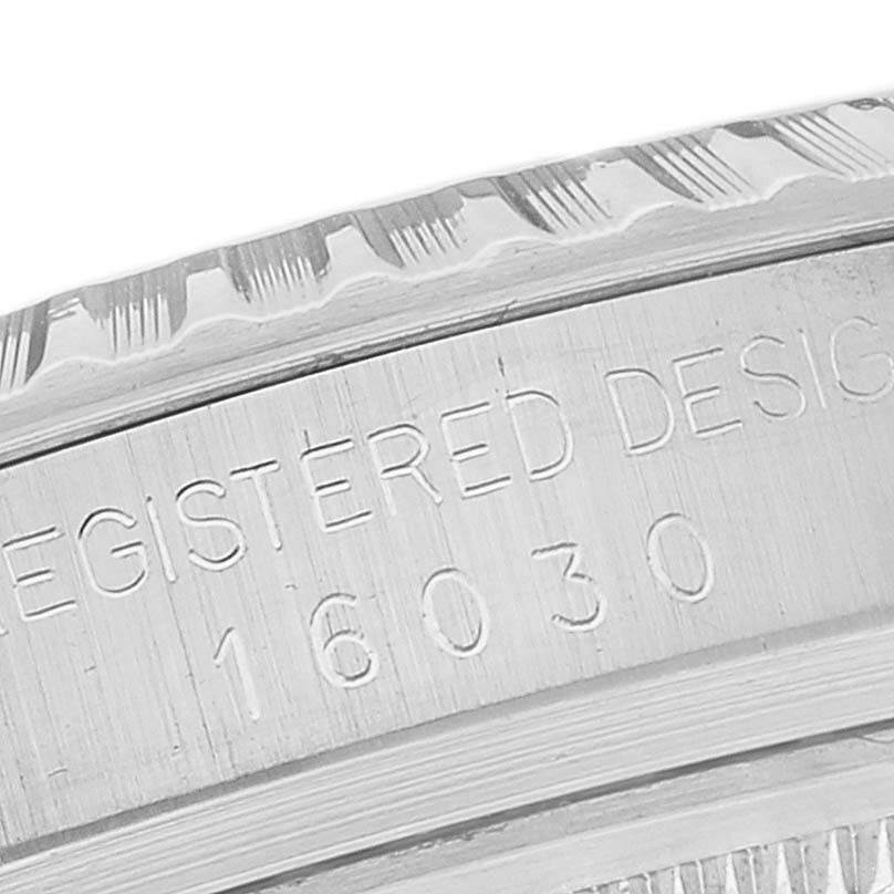 This image shows a close-up of the side of the bezel and case of the Rolex Vintage Collection 16030 Men's Stainless Steel White Dial 16030 Men's Stainless Steel White Dial model, showcasing the engraved serial number.