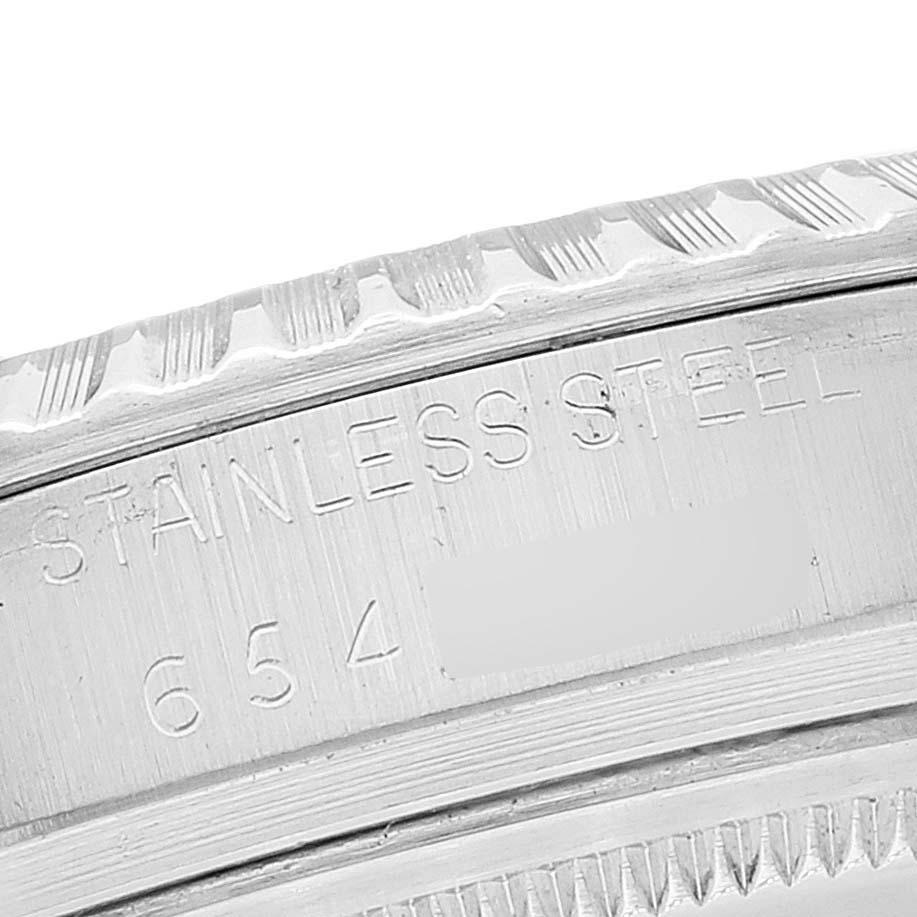 The image shows a close-up of the side engraving on a Rolex Vintage Collection 16030 Men's Stainless Steel White Dial 16030 Men's Stainless Steel White Dial watch, highlighting the stainless steel inscription.