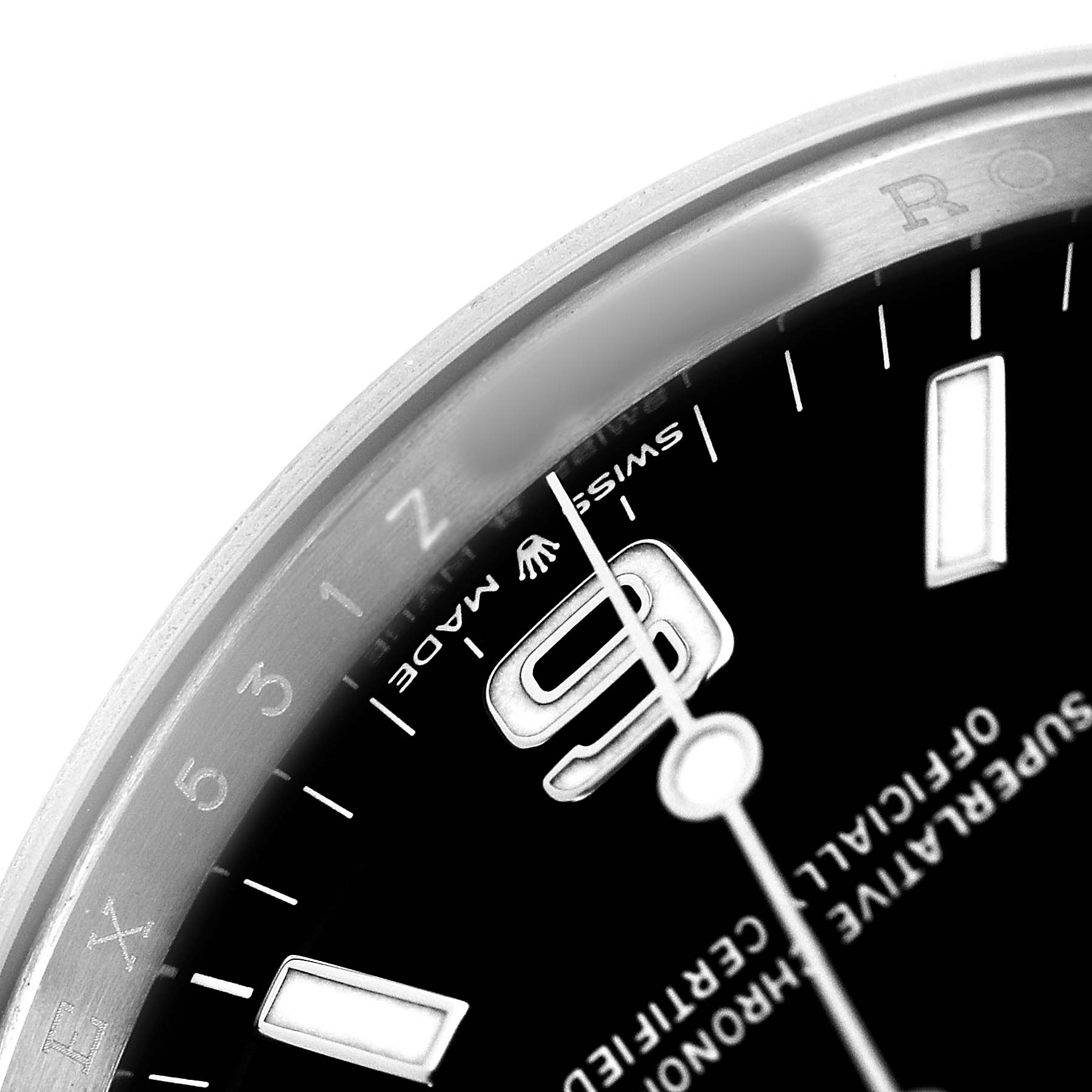The image shows a close-up of the watch dial and bezel of a Rolex Explorer 124270 Men's Stainless Steel Black Dial, highlighting the 9 o'clock marker and surrounding details.