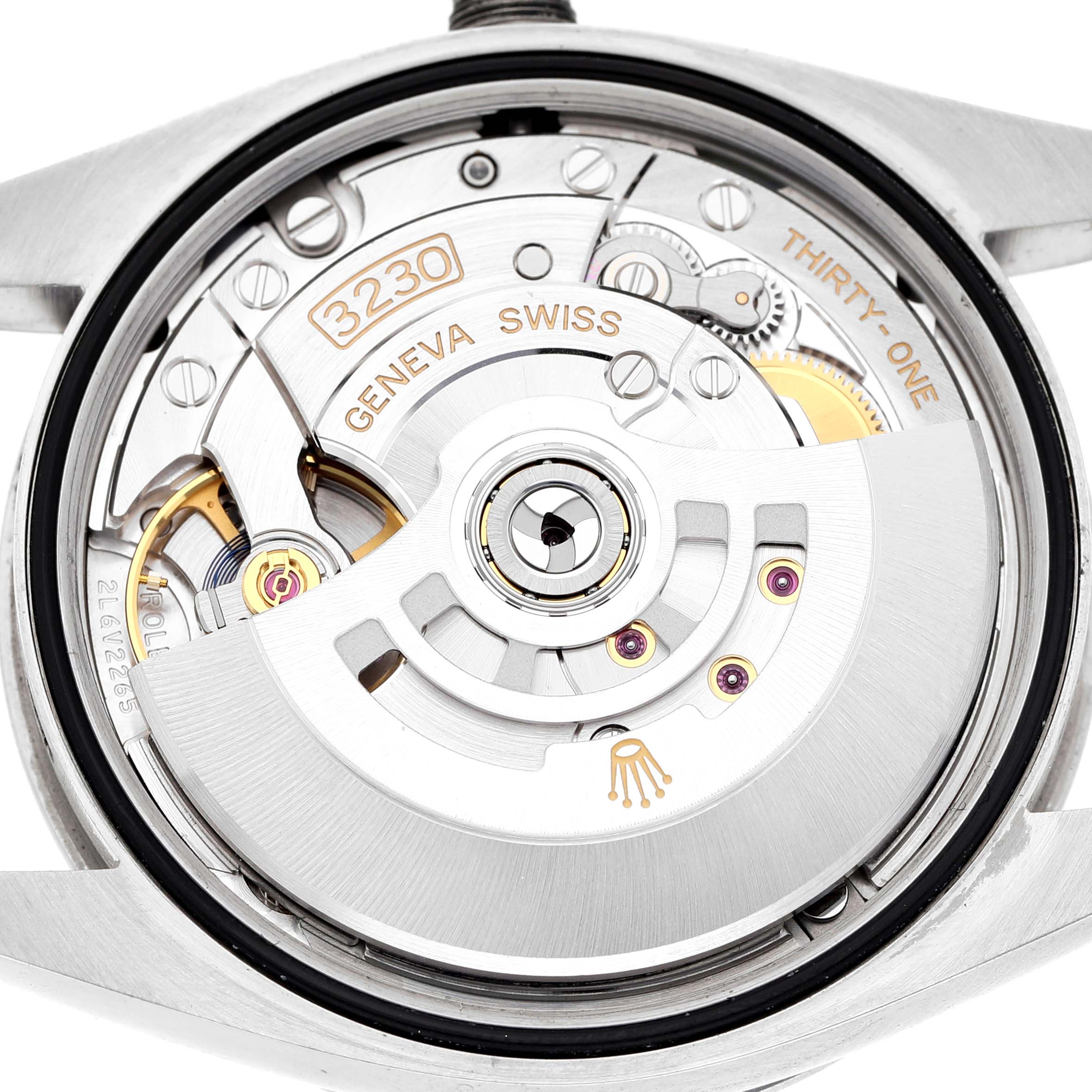 The image shows the back view of a Rolex Explorer 124270 Men's Stainless Steel Black Dial watch, highlighting the movement and rotor with markings like "3230" and "Geneva Swiss."