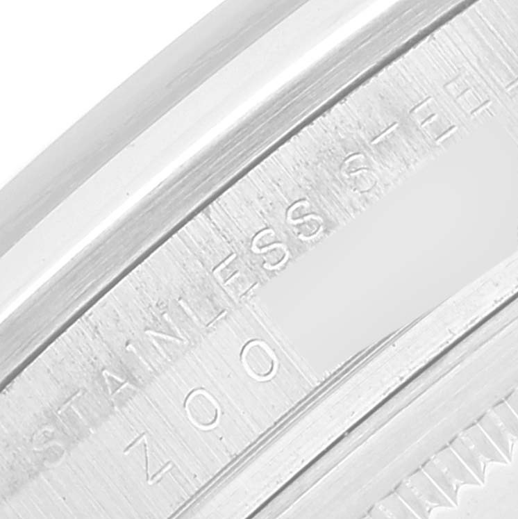 The image shows a close-up of the stainless steel back or casing of a Rolex Explorer 114270 Men
s Stainless Steel Black Dial 114270 Men
s Stainless Steel Black Dial model, highlighting engraved text.