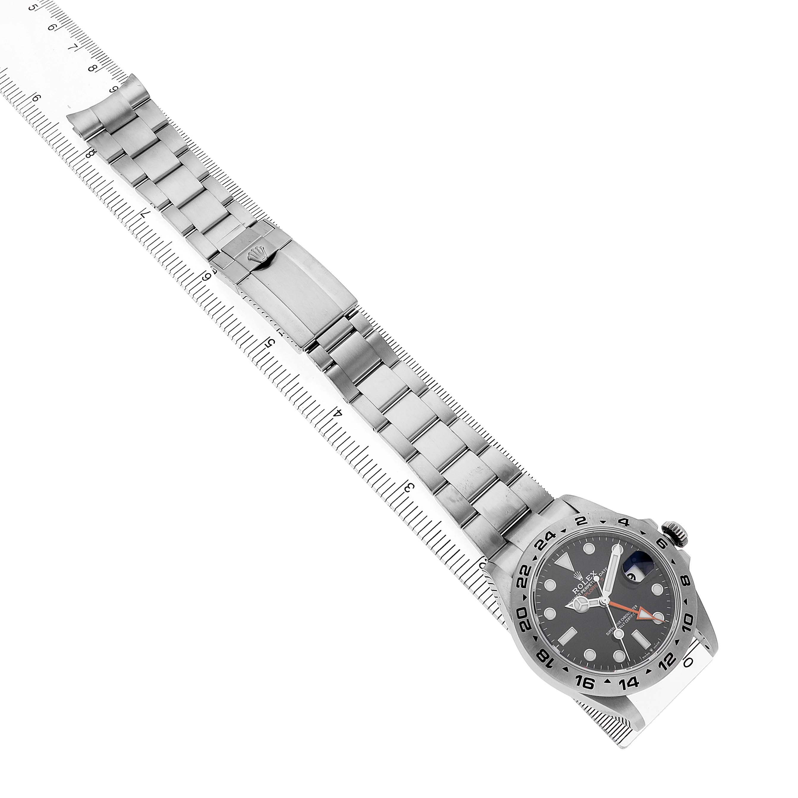 The Rolex Explorer 226570 Men's Stainless Steel Black Dial watch is shown at a diagonal angle, displaying the full metal bracelet and dial.