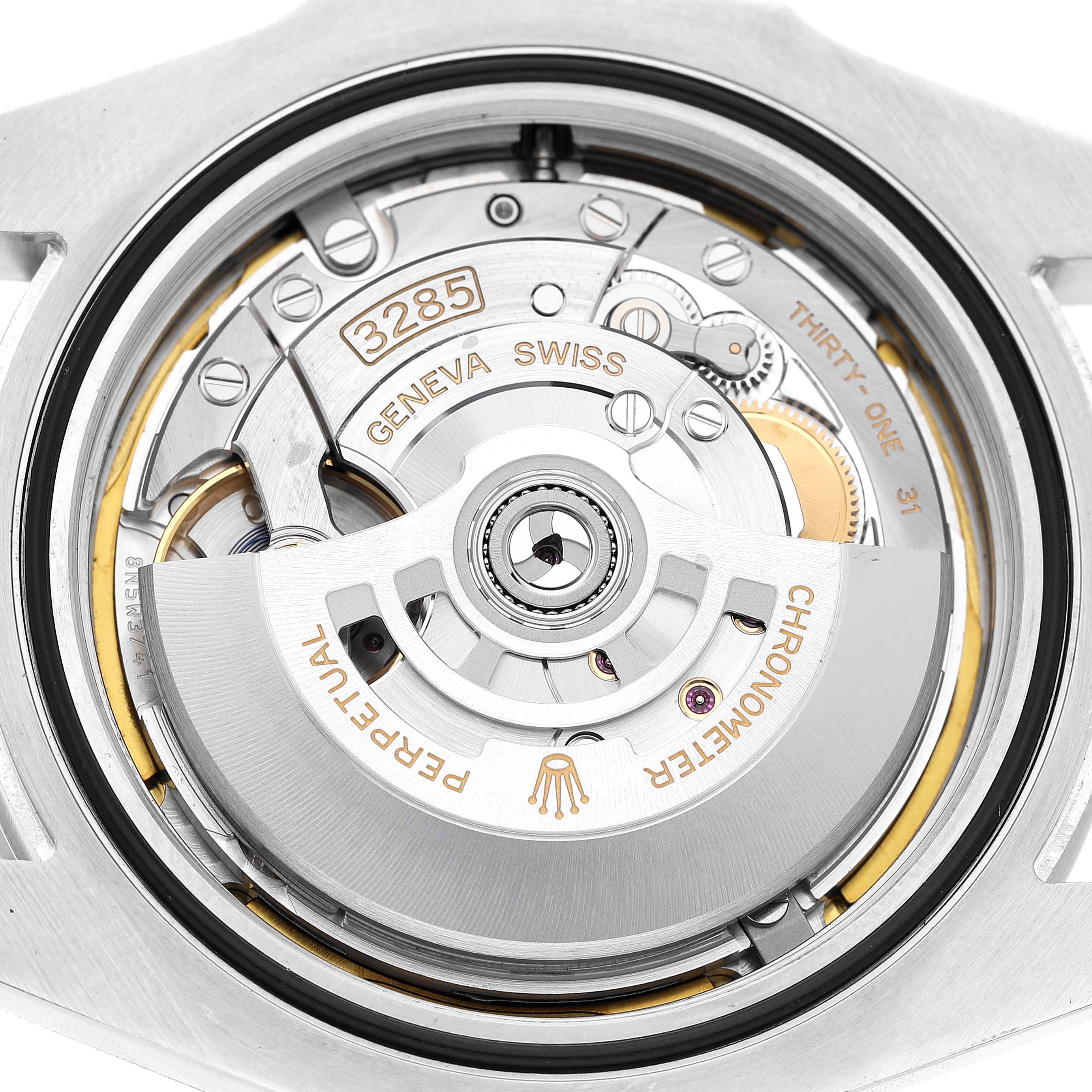 The image shows the movement of a Rolex Explorer 226570 Men's Stainless Steel Black Dial, focusing on its intricate mechanical components and rotor.