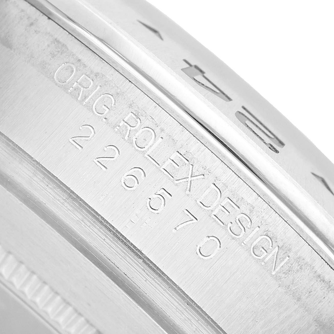 The image shows a close-up of the side of a Rolex Explorer 226570 Men's Stainless Steel Black Dial model, focusing on the engraved design and model number.