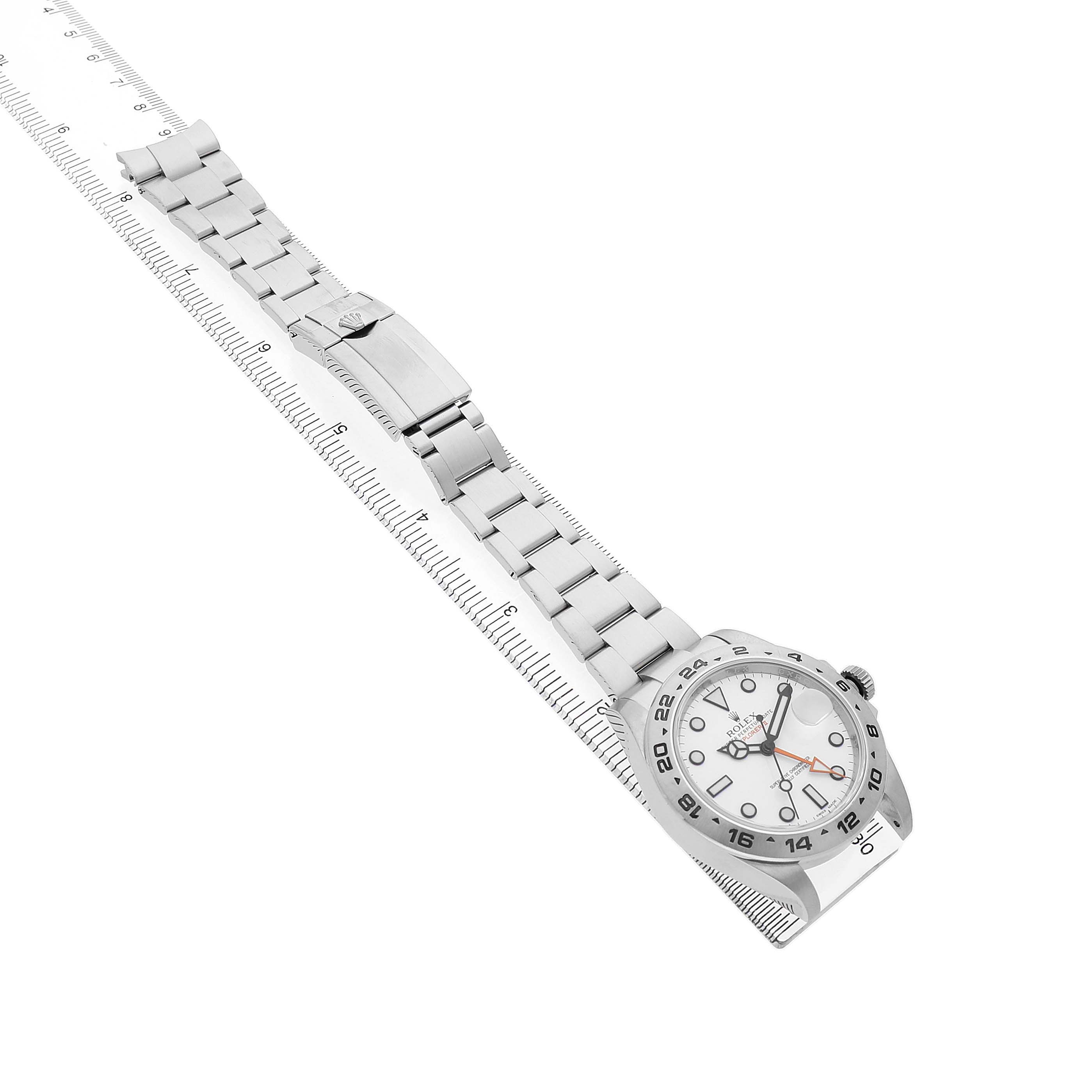 The Rolex Explorer 216570 Men's Stainless Steel White Dial watch is shown at an oblique angle, highlighting the face, bezel, bracelet, and clasp.