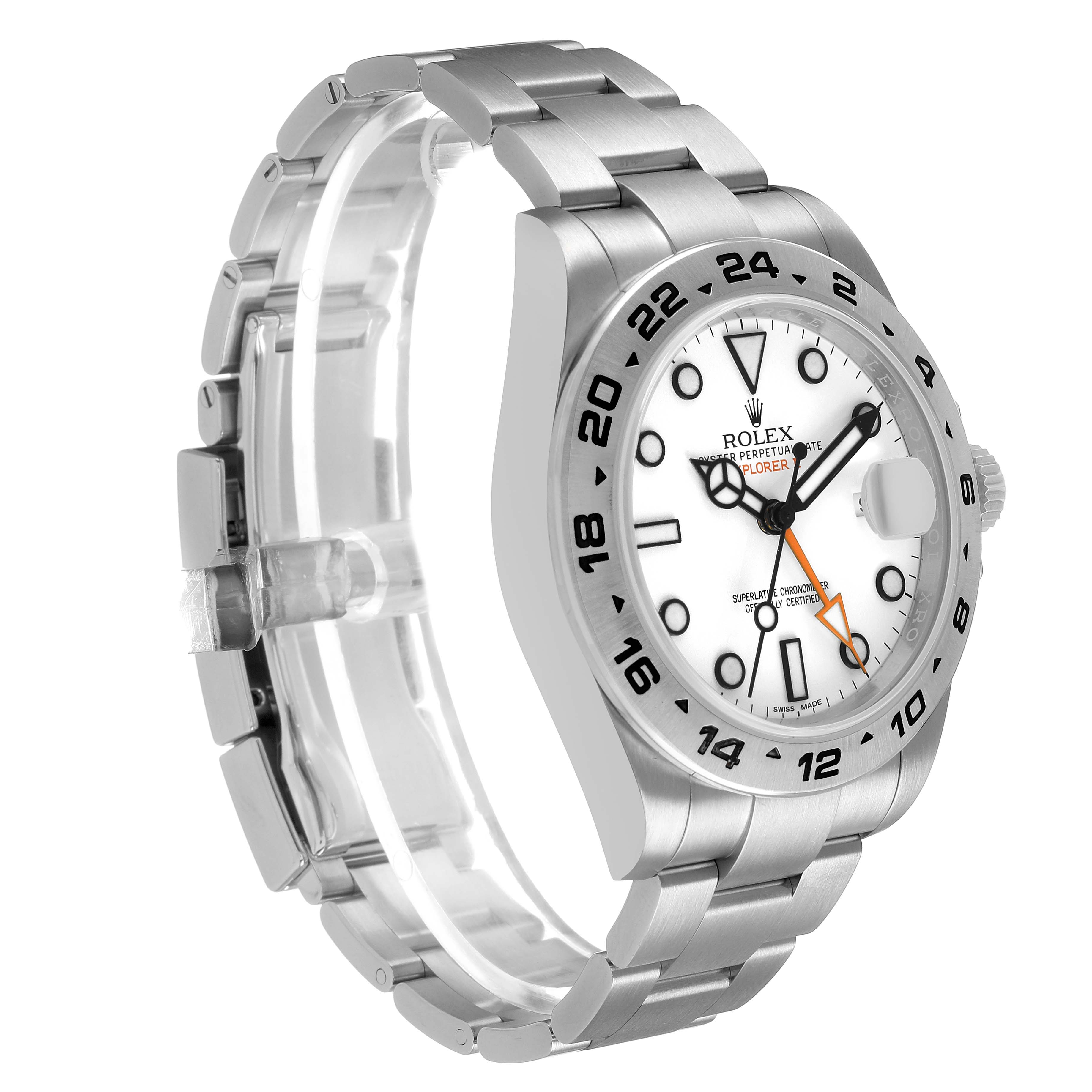 The Rolex Explorer 216570 Men's Stainless Steel White Dial watch is shown at an angle highlighting the face, bezel, crown, and bracelet.