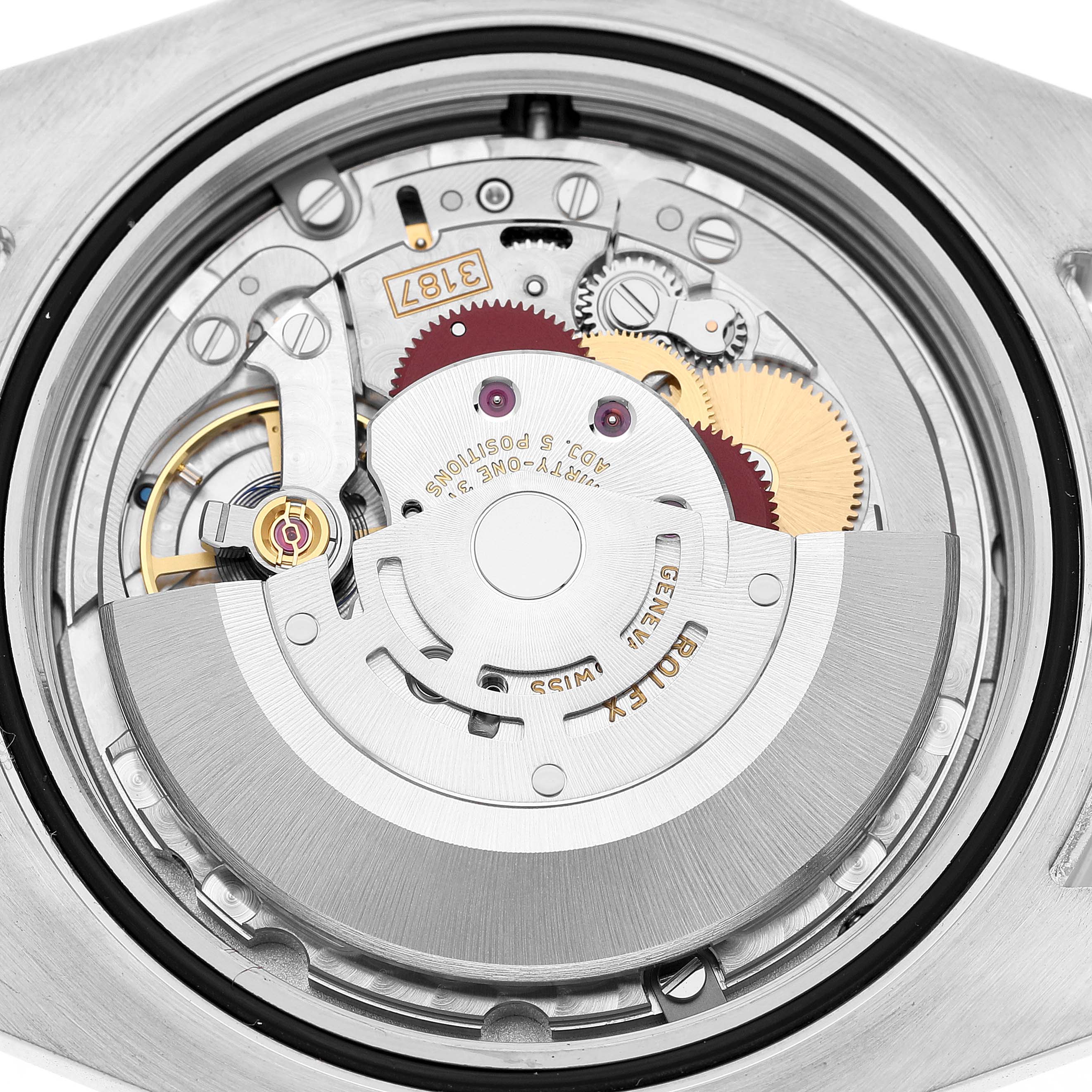The image shows the internal mechanism of a Rolex Explorer 216570 Men's Stainless Steel White Dial watch from a back view, highlighting gears and the rotor.