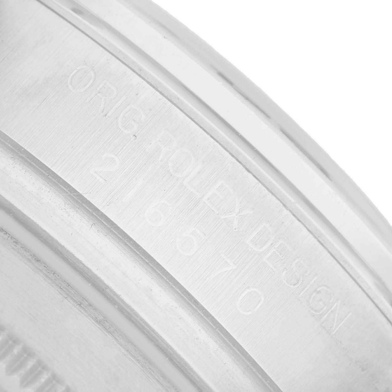 The image shows a close-up of the engraved inner bezel of a Rolex Explorer 216570 Men's Stainless Steel White Dial watch.