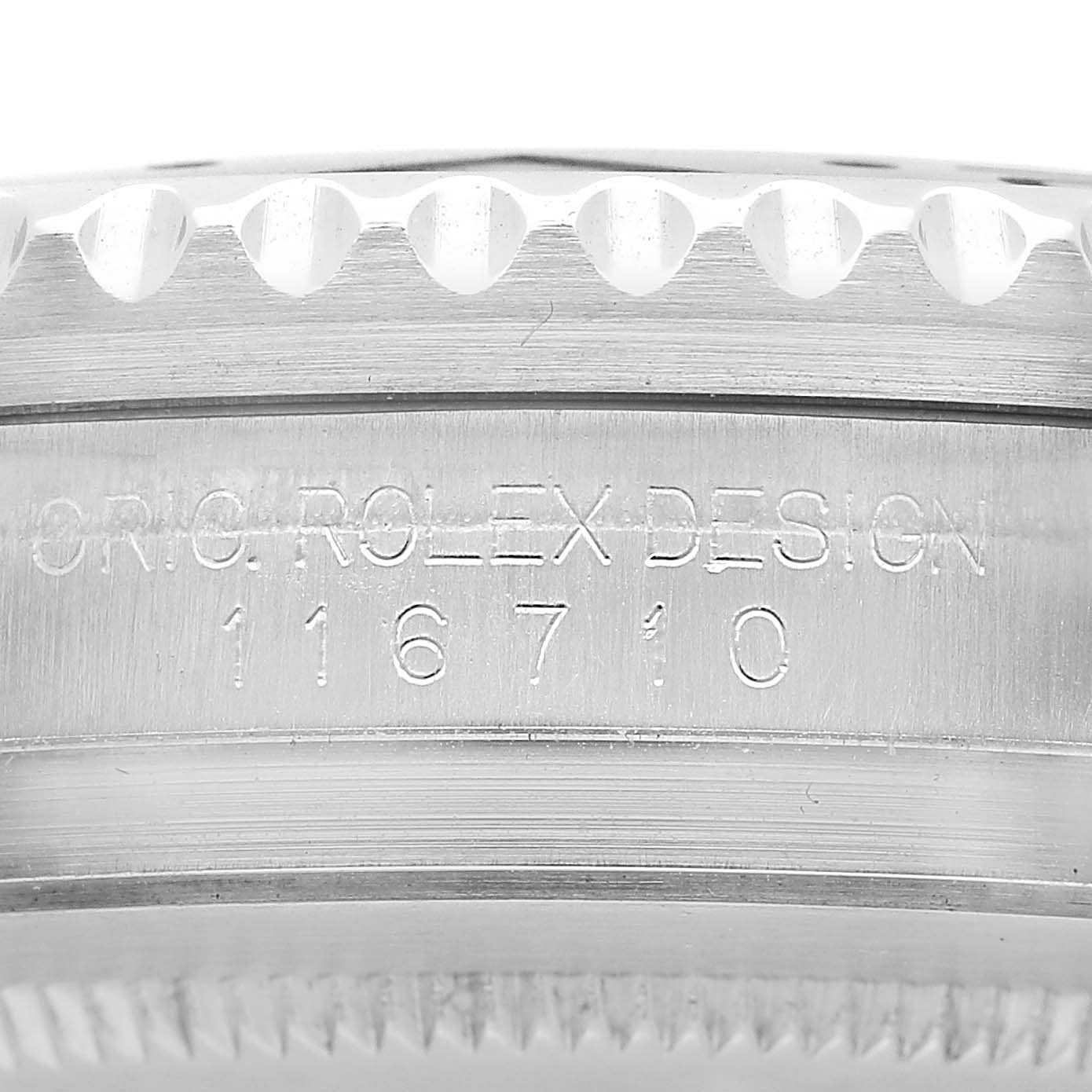 The image shows the side profile of the Rolex GMT-Master 116710 Men's Stainless Steel Black Dial model, featuring engraved text and a section of the bezel.