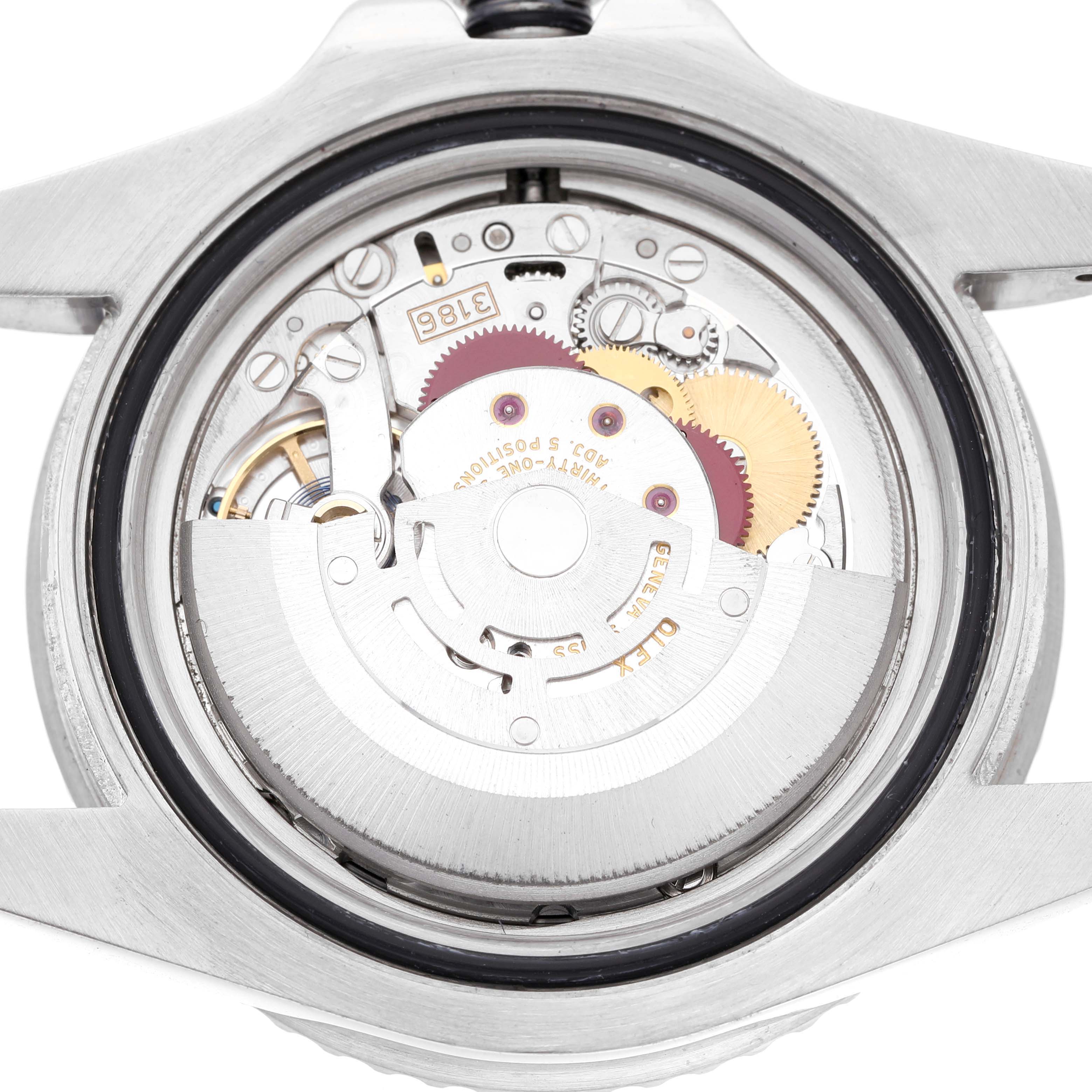 The image shows the movement mechanism of a Rolex GMT-Master 116710 Men's Stainless Steel Black Dial, viewed from the back with visible gears and rotor.