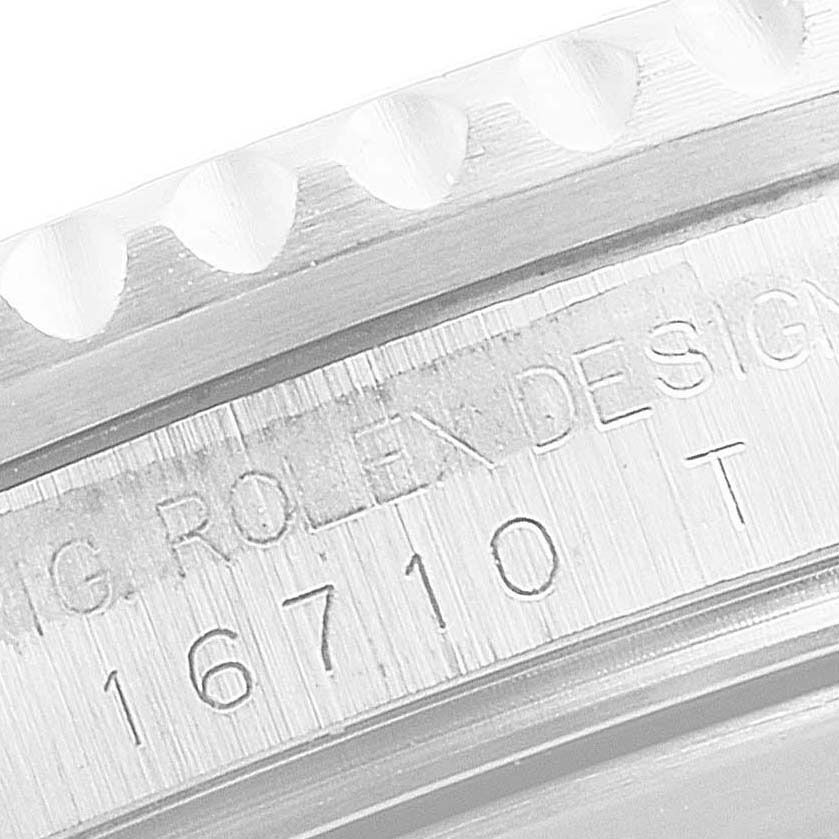 This close-up image shows the engraved serial number and part of the bezel teeth of a Rolex GMT-Master 16710 Men
s Stainless Steel Black Dial 16710 Men
s Stainless Steel Black Dial watch.