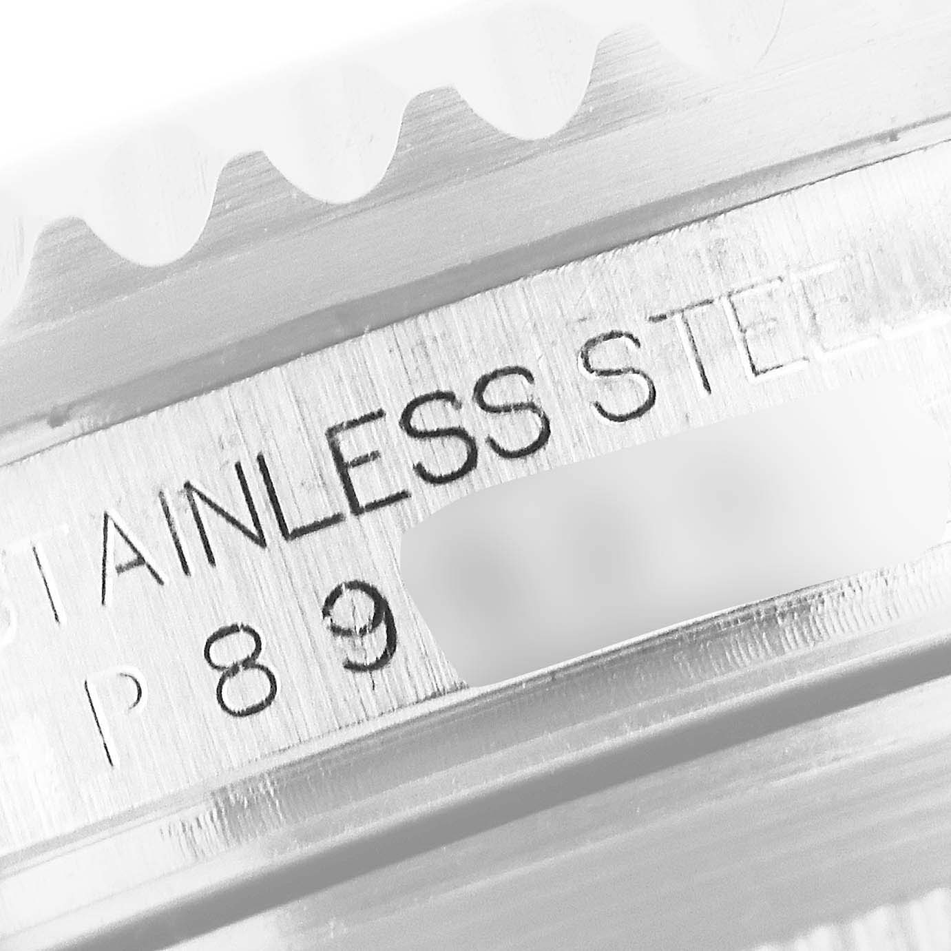 The image shows a close-up of the side of a Rolex GMT-Master 16710 Men
s Stainless Steel Black Dial 16710 Men
s Stainless Steel Black Dial watch, focusing on the stainless steel casing and some engraved details.