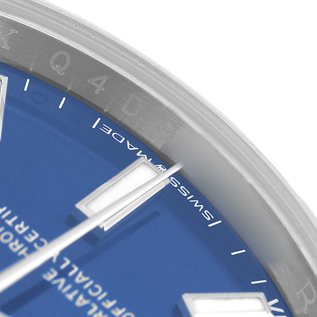 The image shows a close-up angle of the Rolex Oyster Perpetual 124200 Men's Stainless Steel Blue Dial watch face, highlighting the blue dial, markers, and part of the bezel.