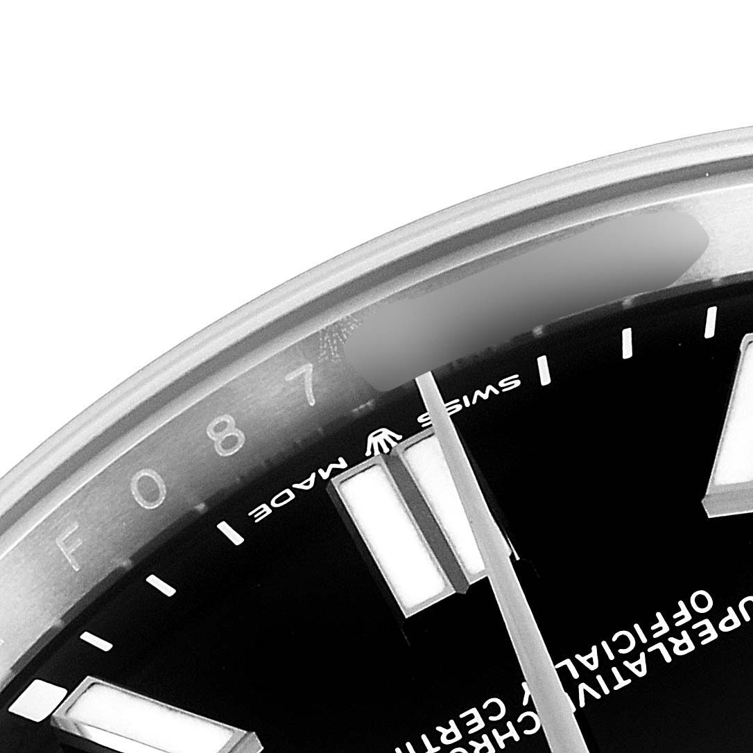 The image shows a close-up of the dial and bezel of a Rolex Oyster Perpetual 124300 Men
s Stainless Steel Black Dial 124300 Men
s Stainless Steel Black Dial watch, highlighting markers and the "Swiss Made" text.